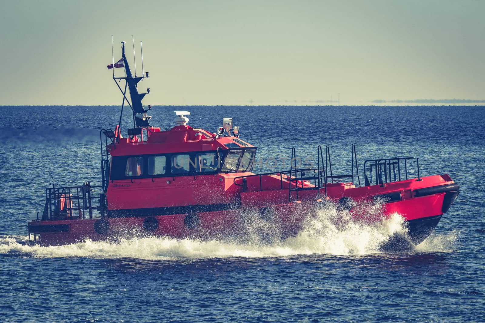 Red pilot ship moving from the Baltic sea