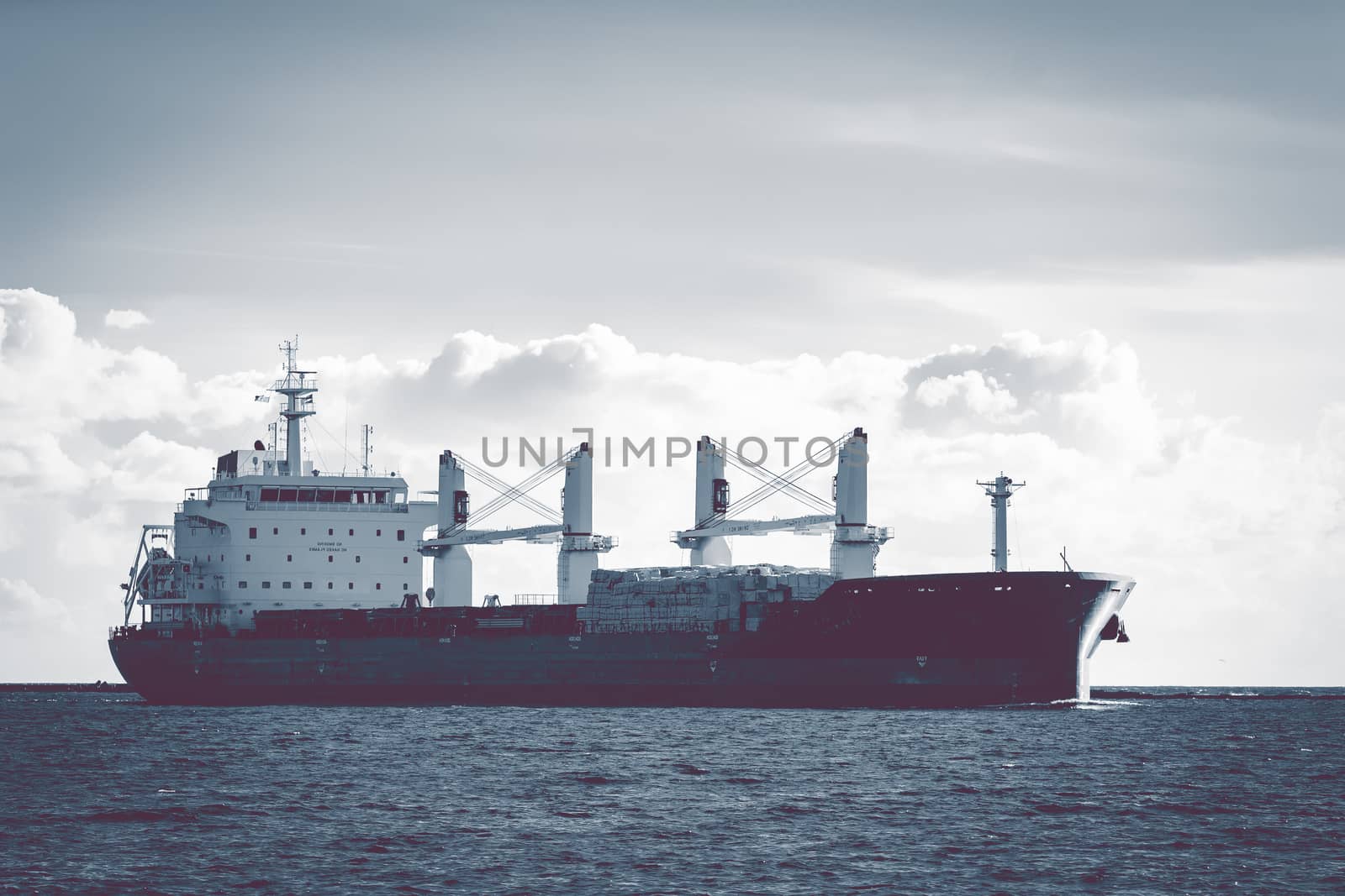 Cargo ship moving entering the port of Riga