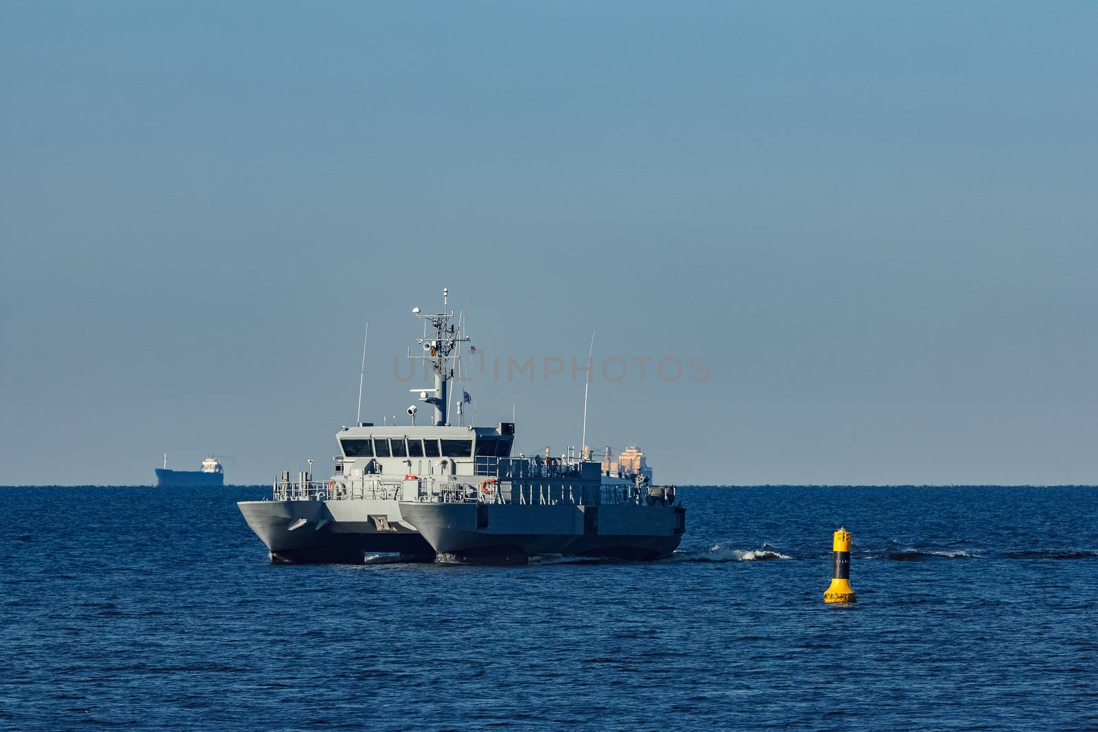 Small grey military ship moving from Baltic sea