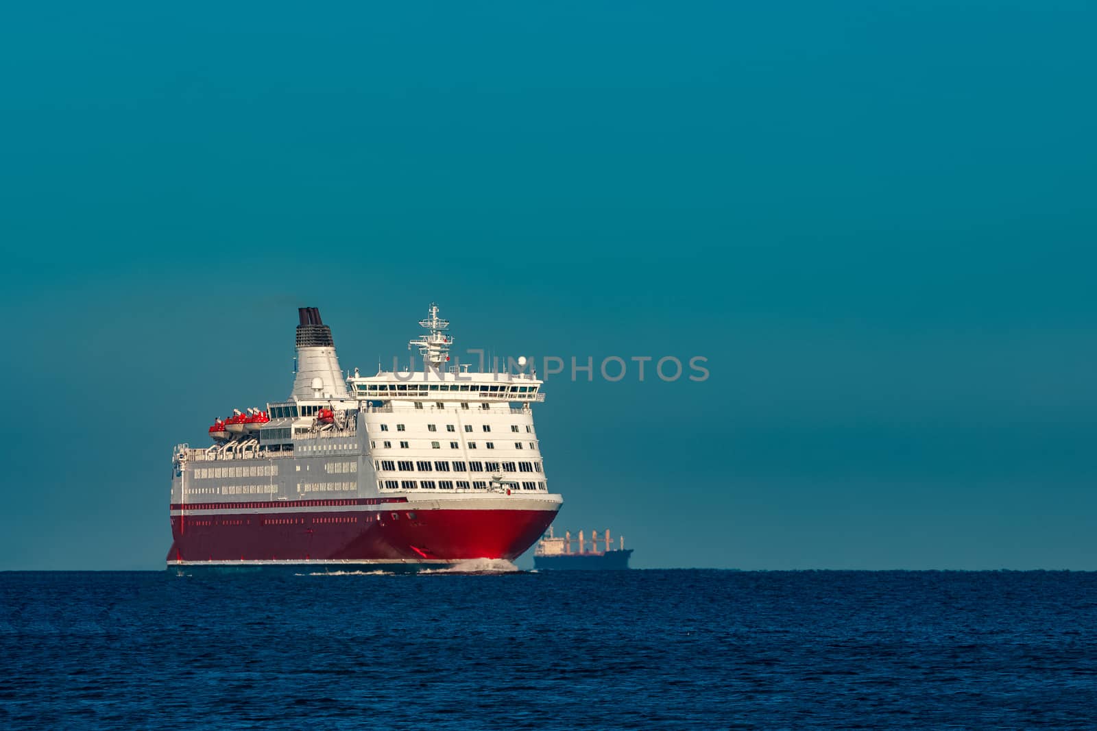 Red cruise liner. Large passenger ferry underway