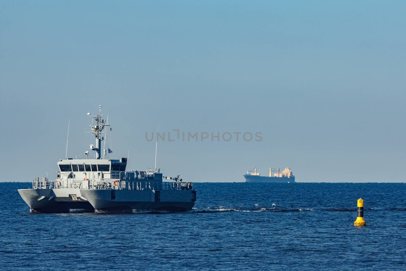 Small grey military ship moving from Baltic sea