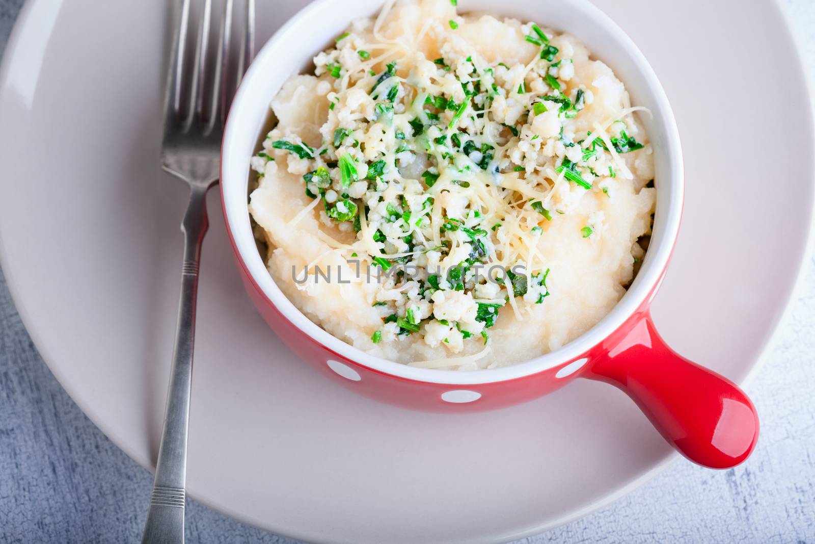Fish pie with celery root with fork on a white plate