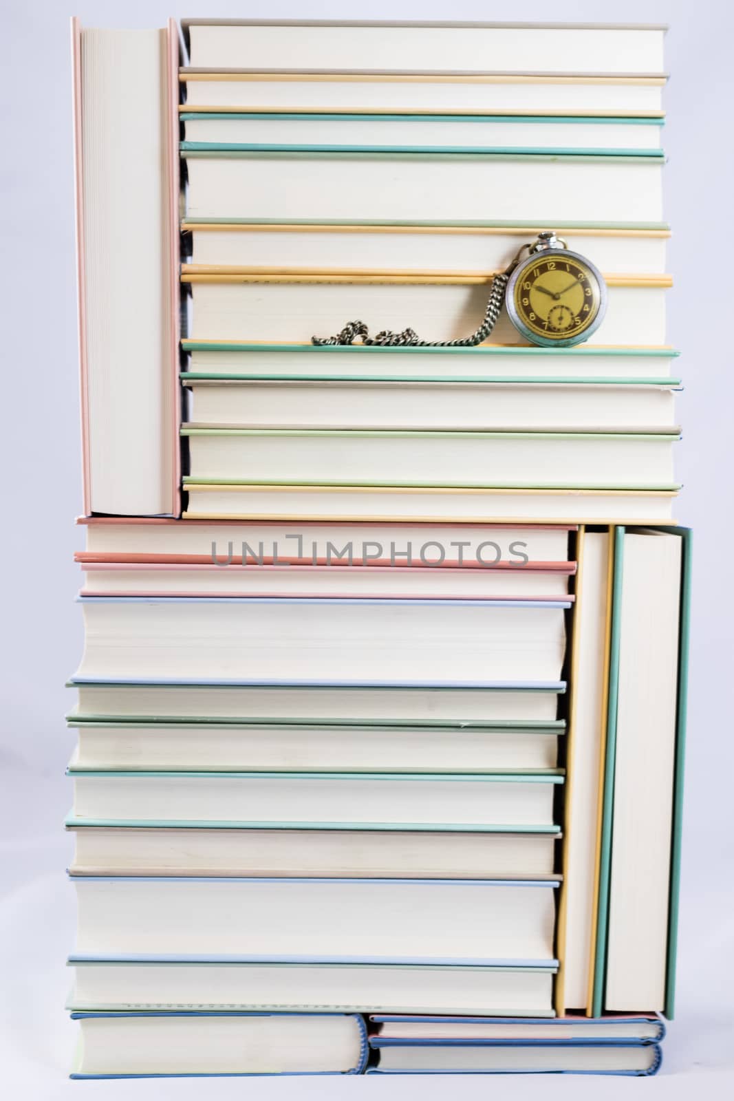 Heap of books on a white isolated background with a nib