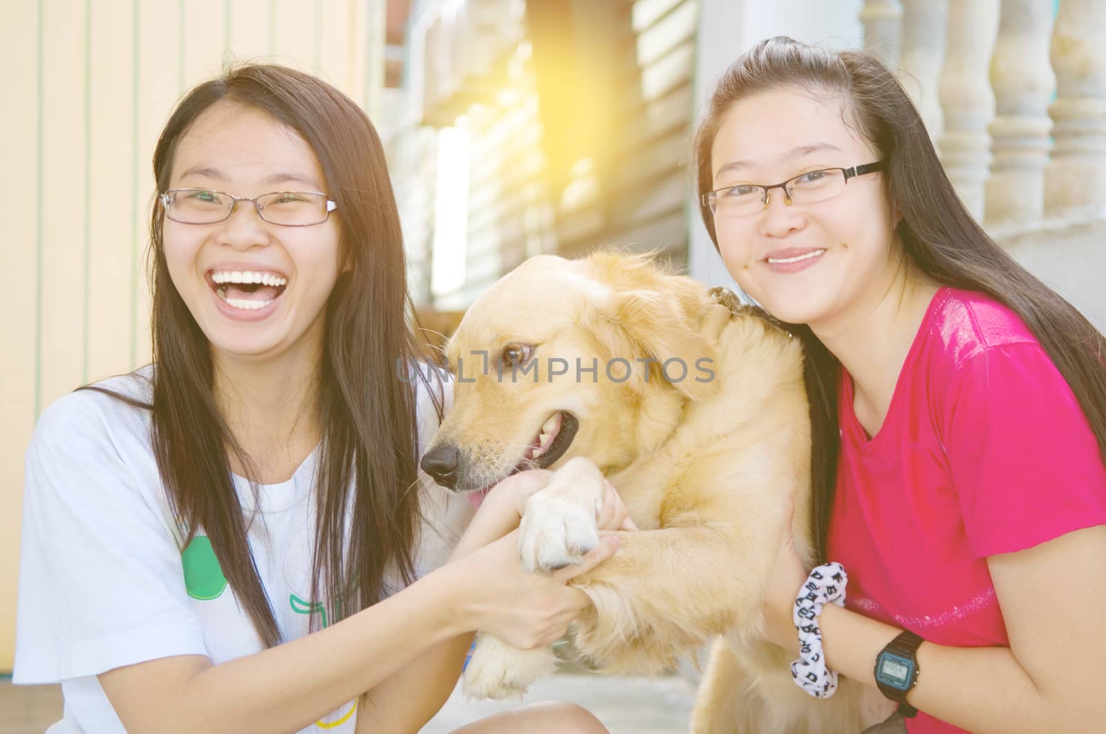 Pretty asian girls playing with a dog outdoor