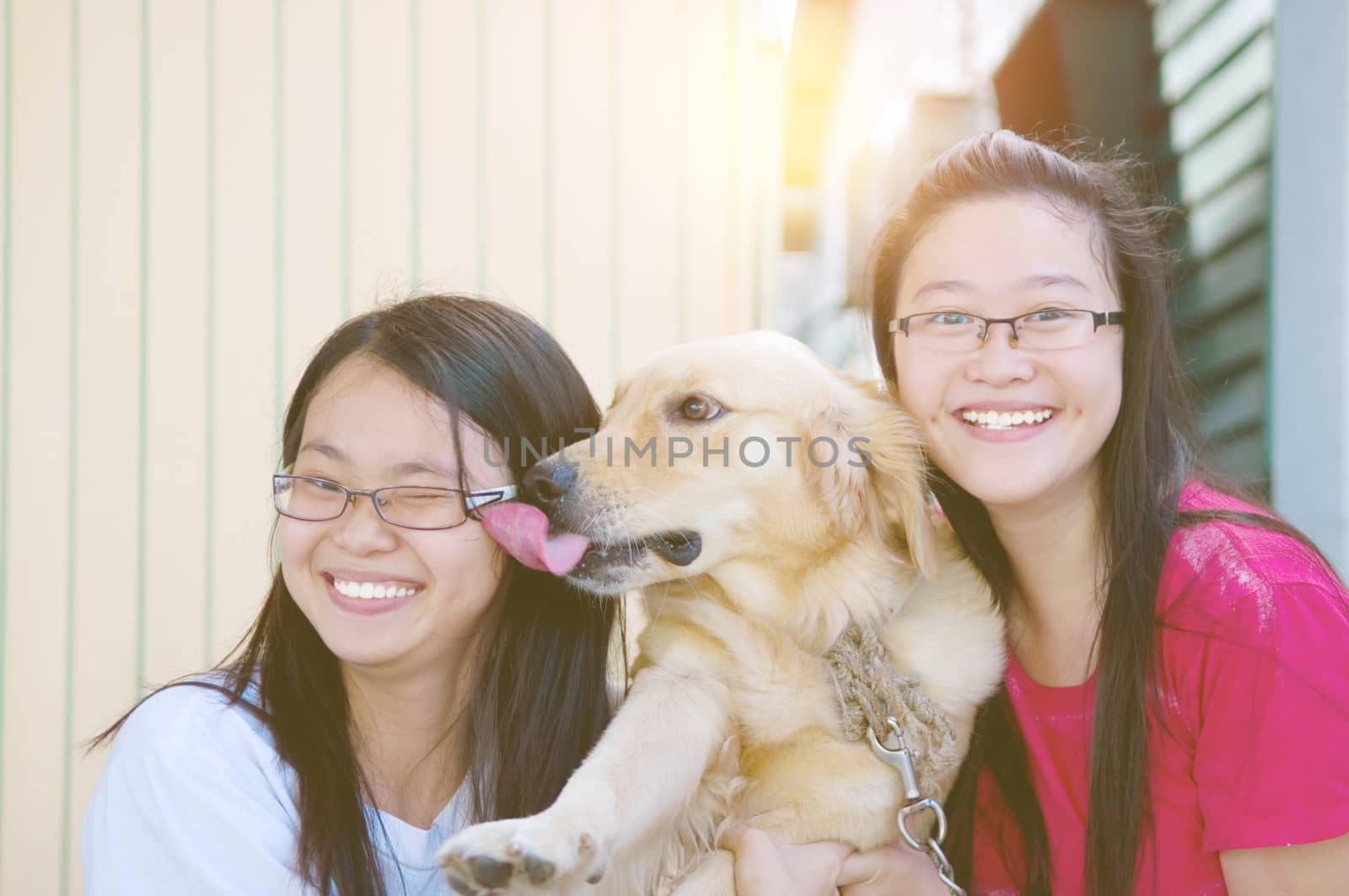 Pretty asian girls playing with a dog outdoor