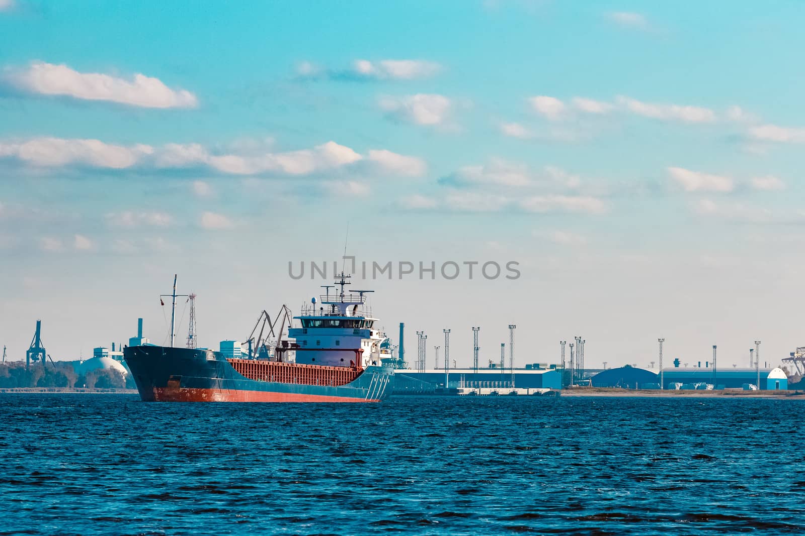 Blue cargo ship moving to the cargo port