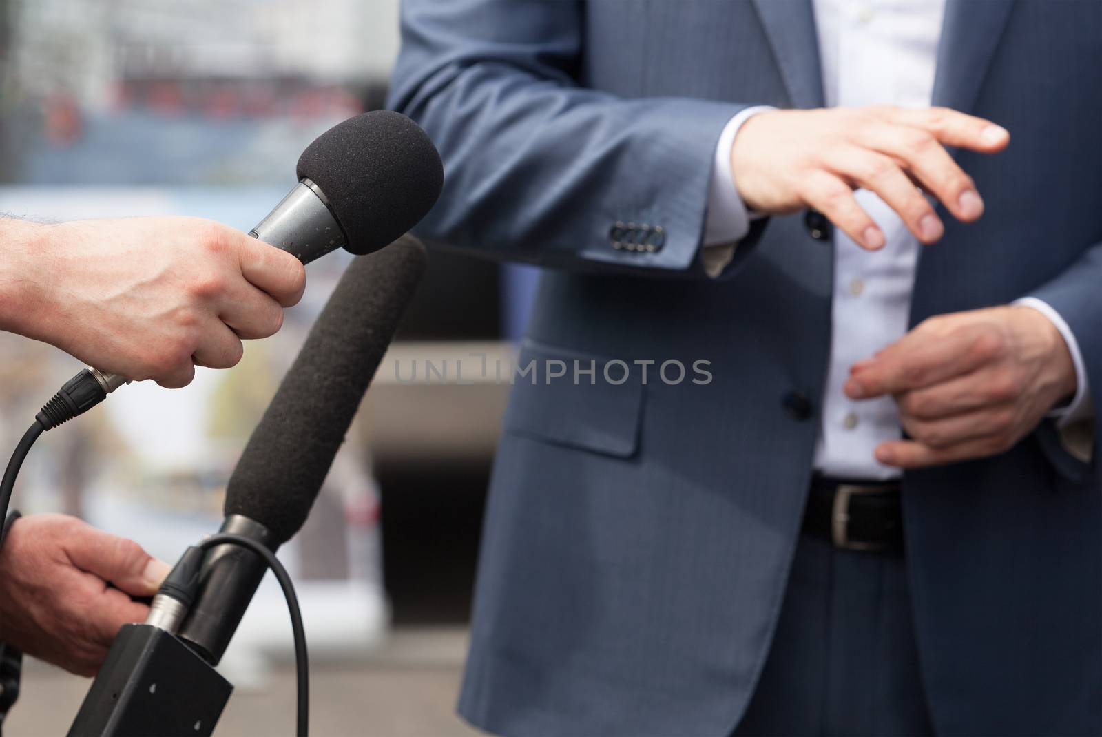 Reporters making interview with businessperson, politician or spokesman. News conference.
