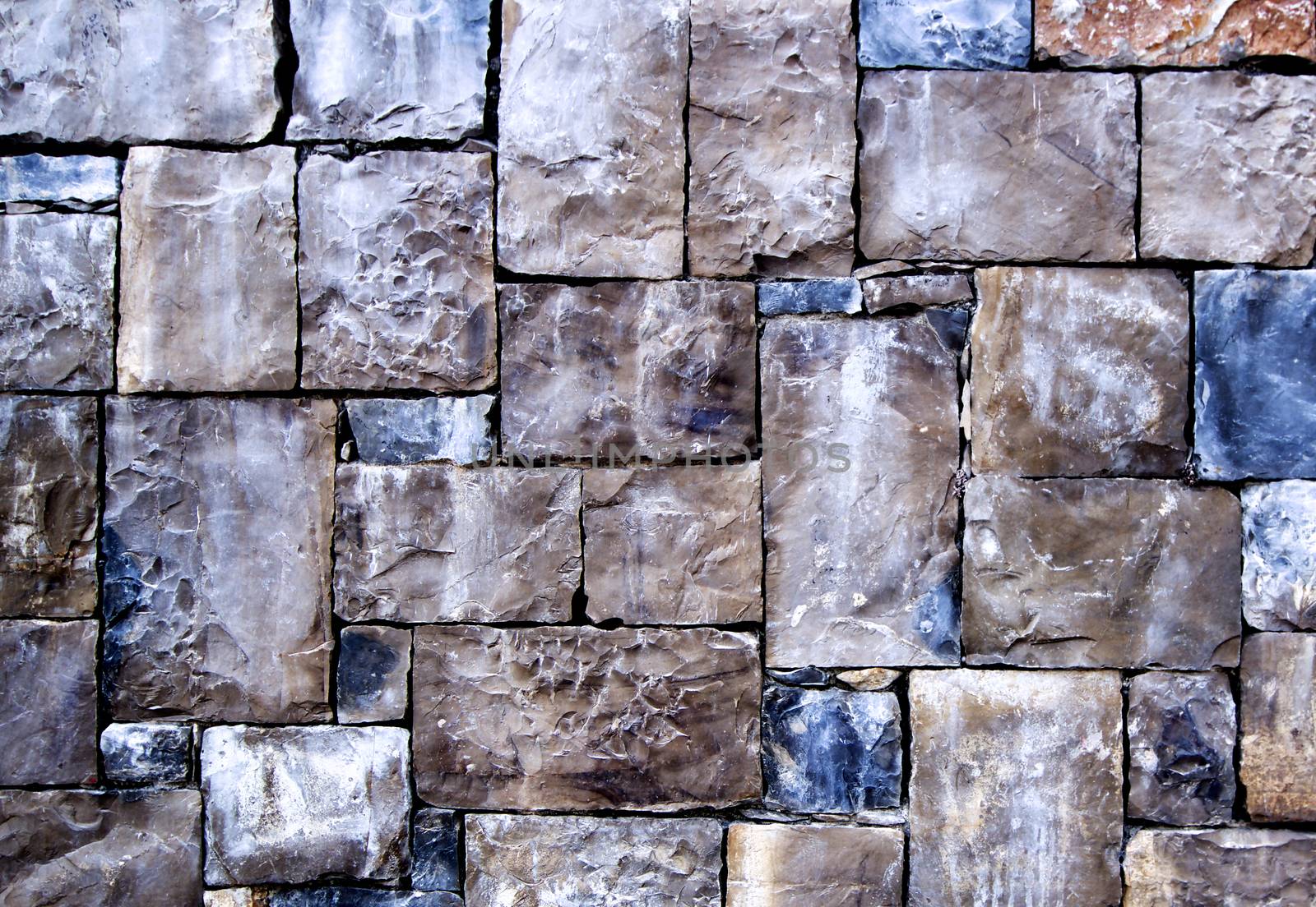 Background of Multi-Colored Cobblestones with Sharp Spears closeup Outdoors