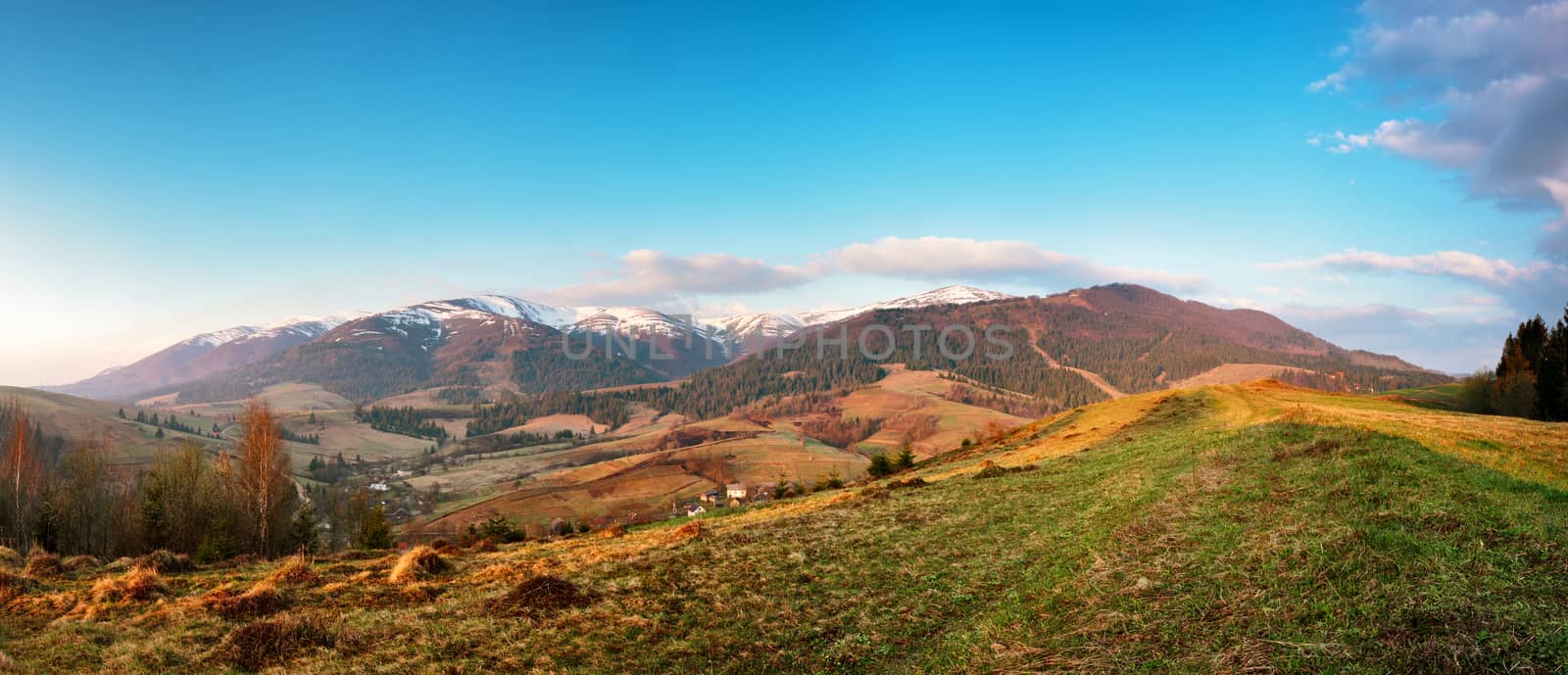 Panorama view of snow capped mountain peaks in spring time. Mountains in morning light.
Idyllic Spring alpine morning landscape with fresh green meadows and snow-capped mountain tops in the background.
