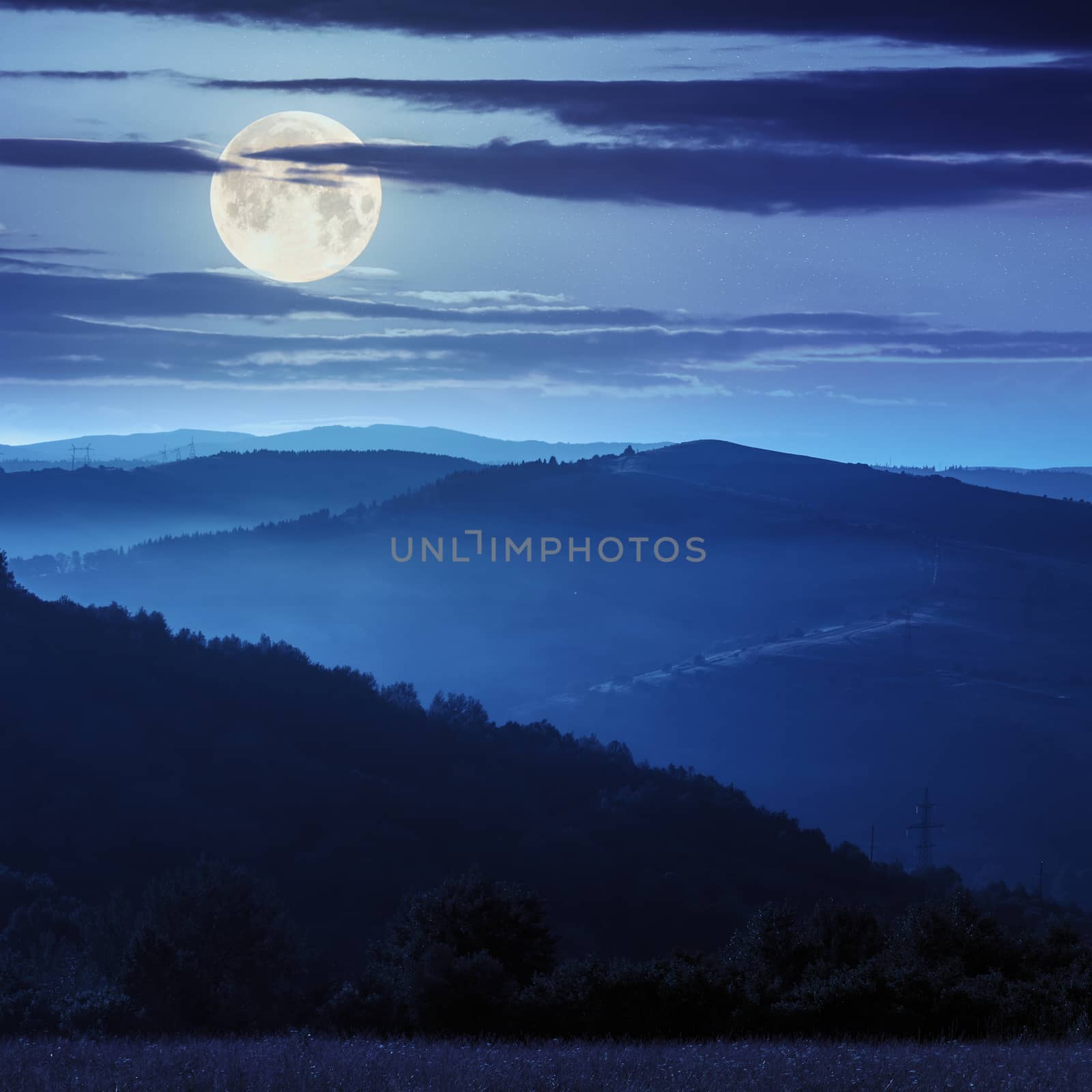 cold fog on before sunrise in mountains in moon light by Pellinni