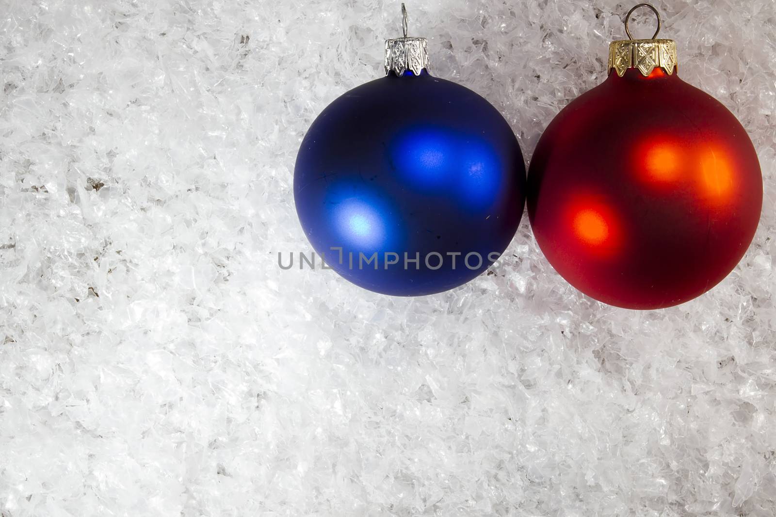 Blue and red Christmas balls on the white snow