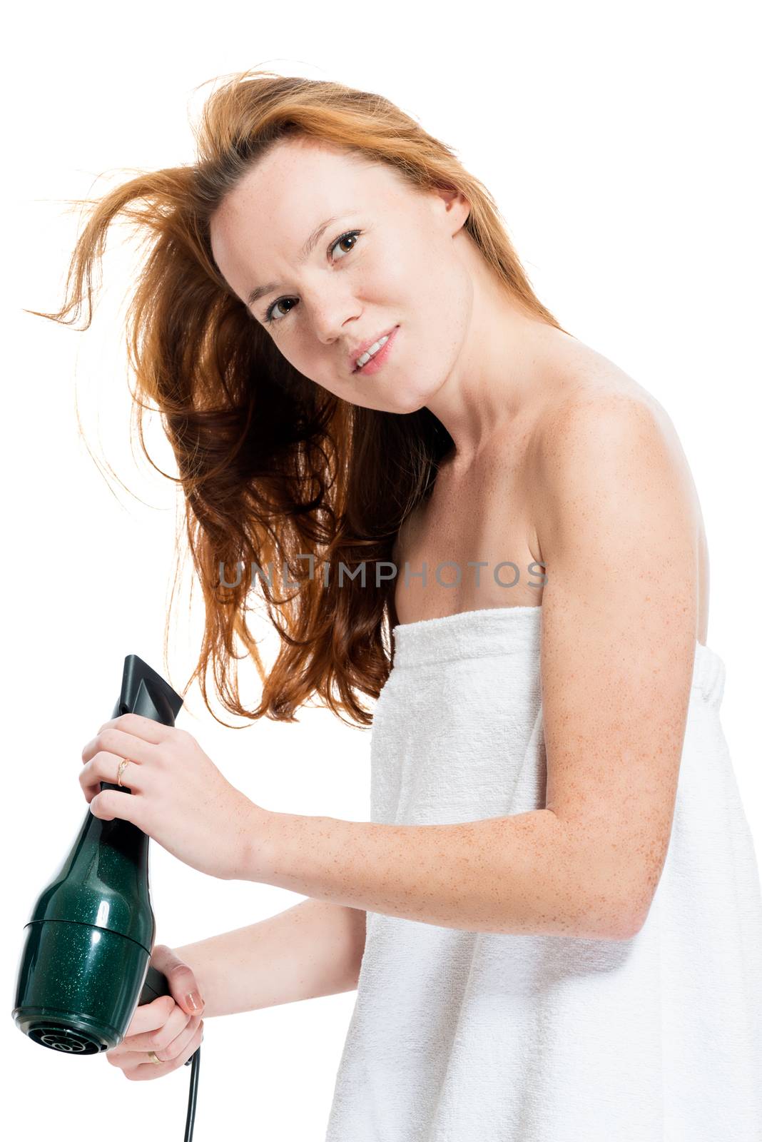 Portrait of a slender girl in a towel with a hairdryer on a white background