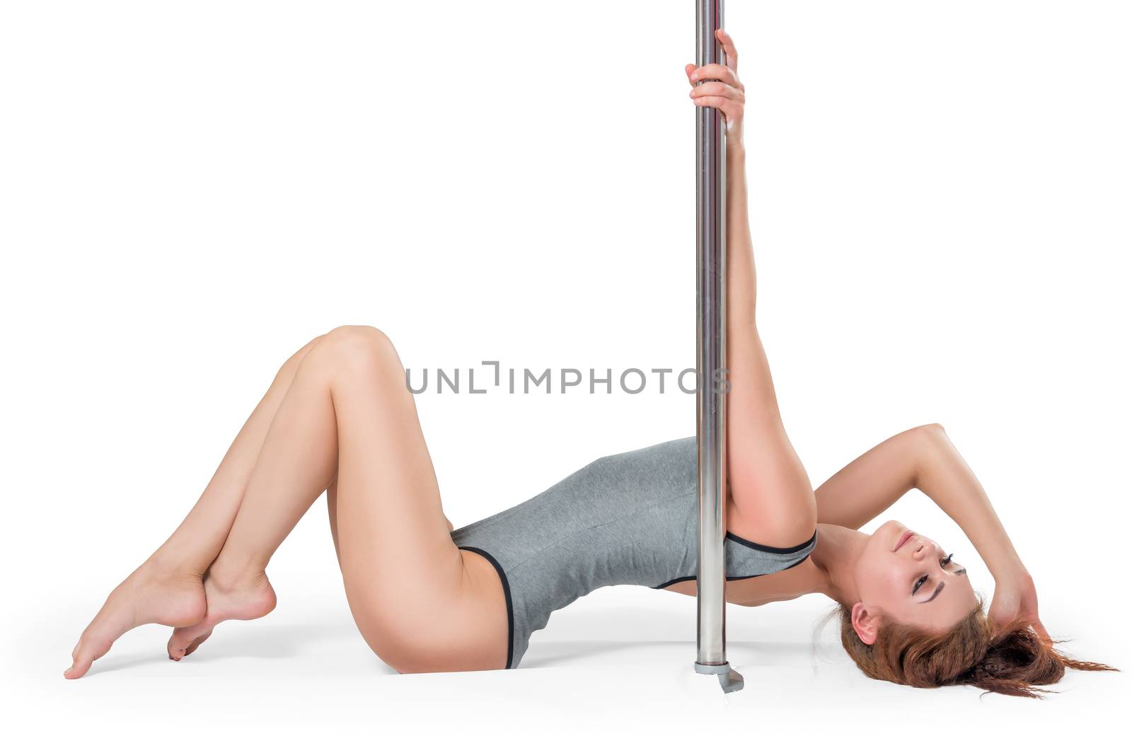 Beautiful young girl near a pylon lies on the floor