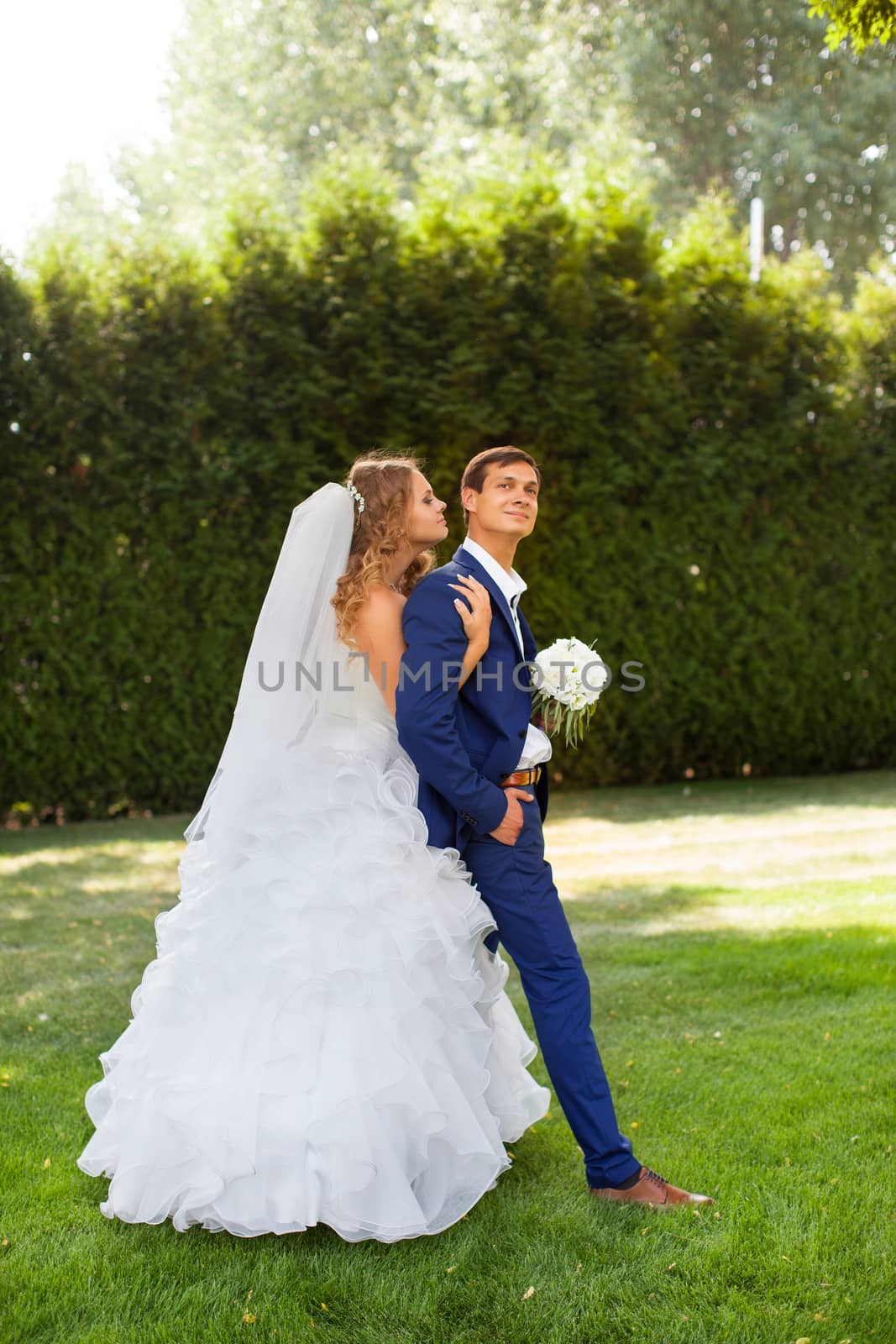 Newlyweds on a walk in the park on a warm sunny day