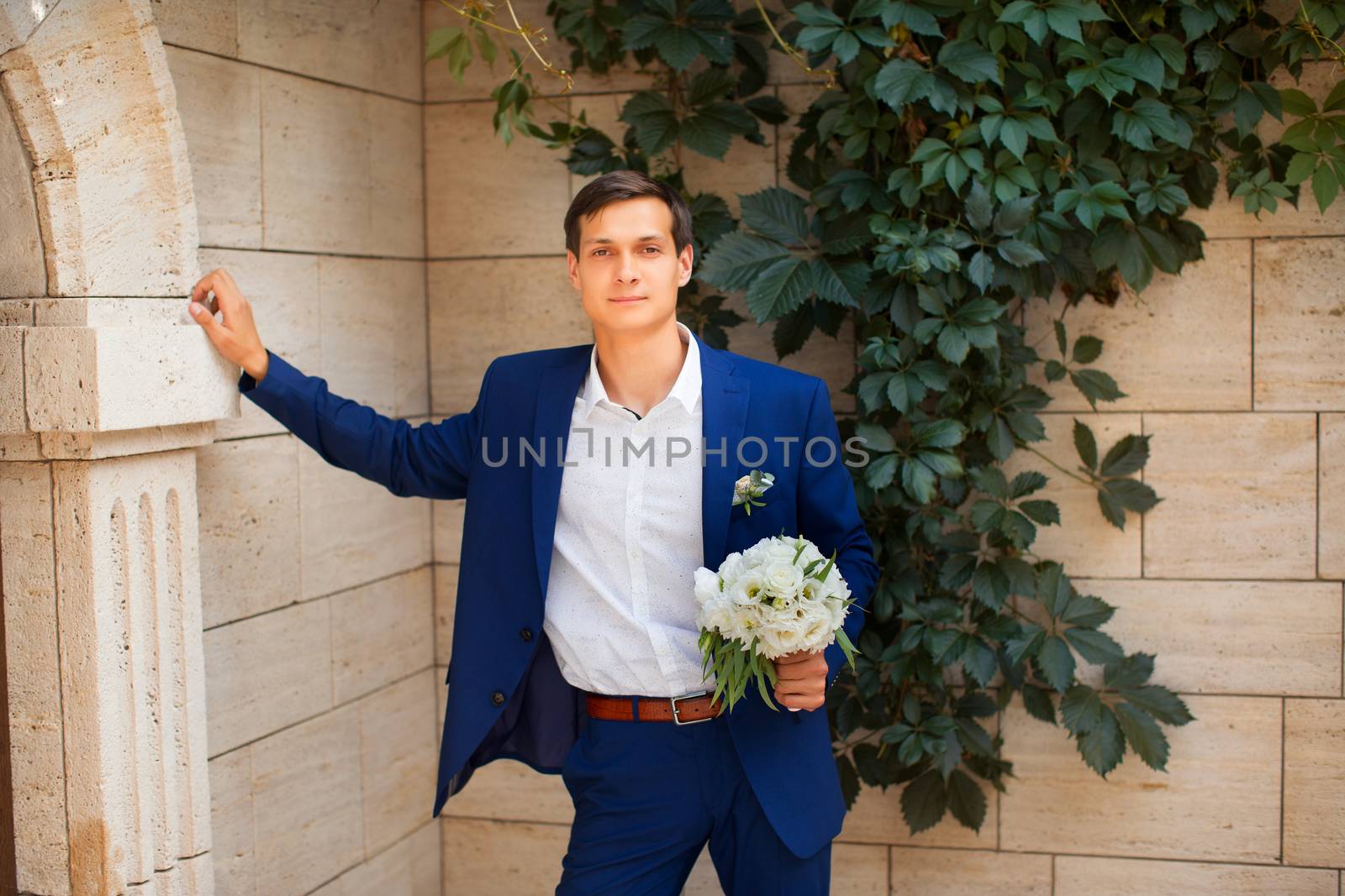 Portrait of the groom in an expensive suit