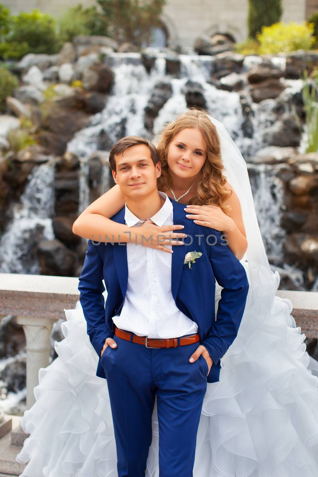 Newlyweds on a walk in the park on a warm sunny day