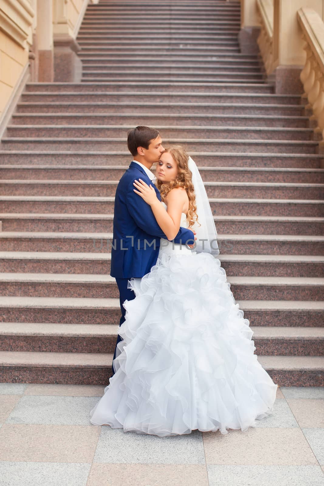 Newlyweds on a walk in the park on a warm sunny day