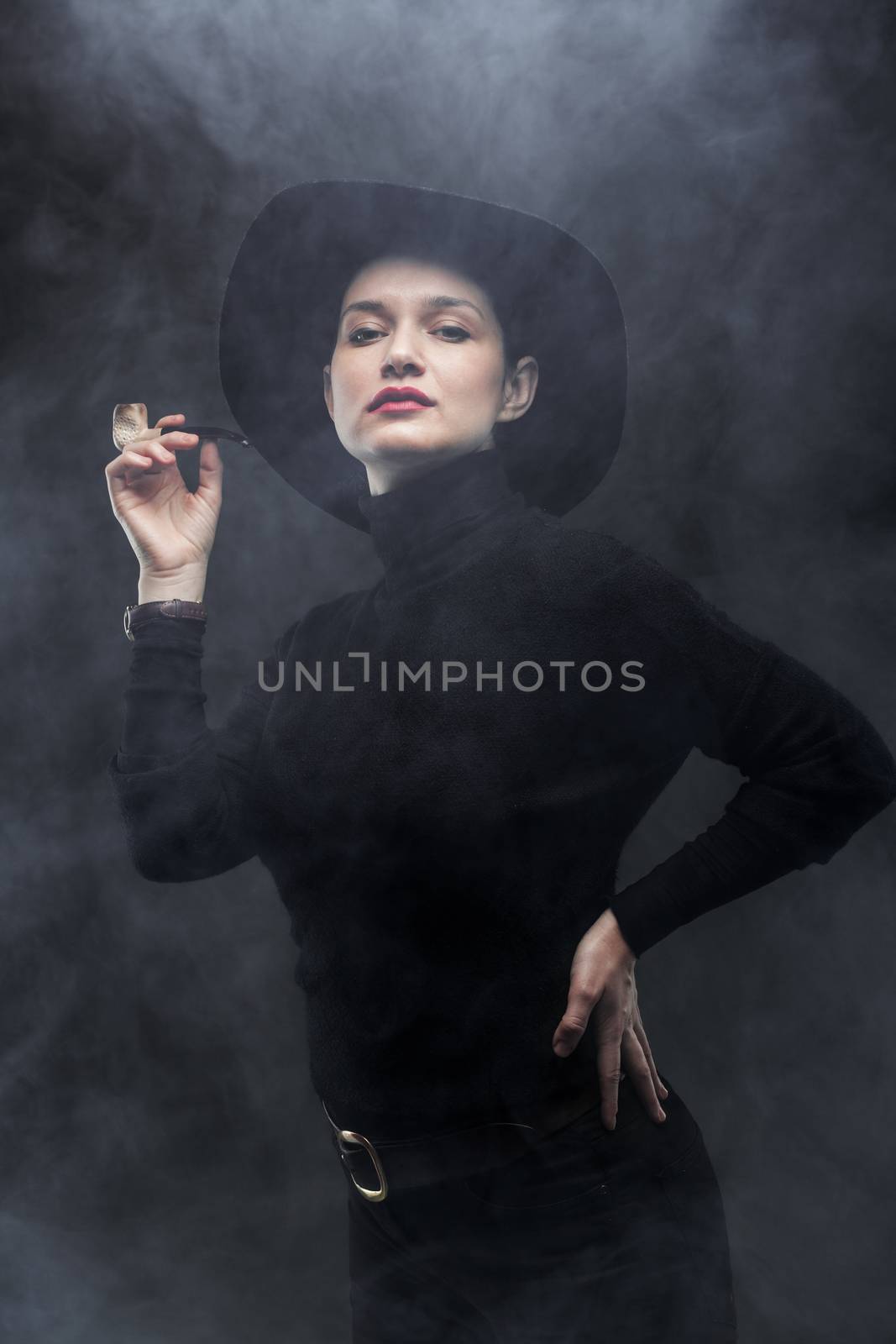 girl in black holding a pipe on smoke background