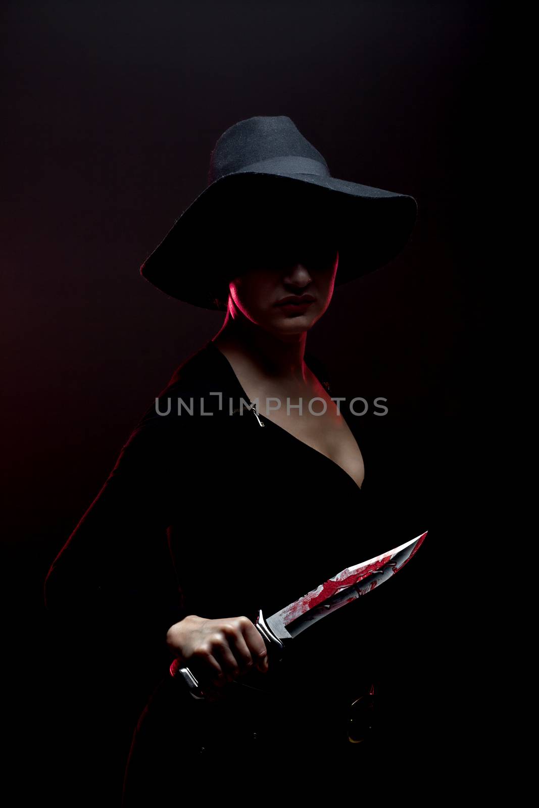 girl with a huge bloody knife in shadow, red backlight