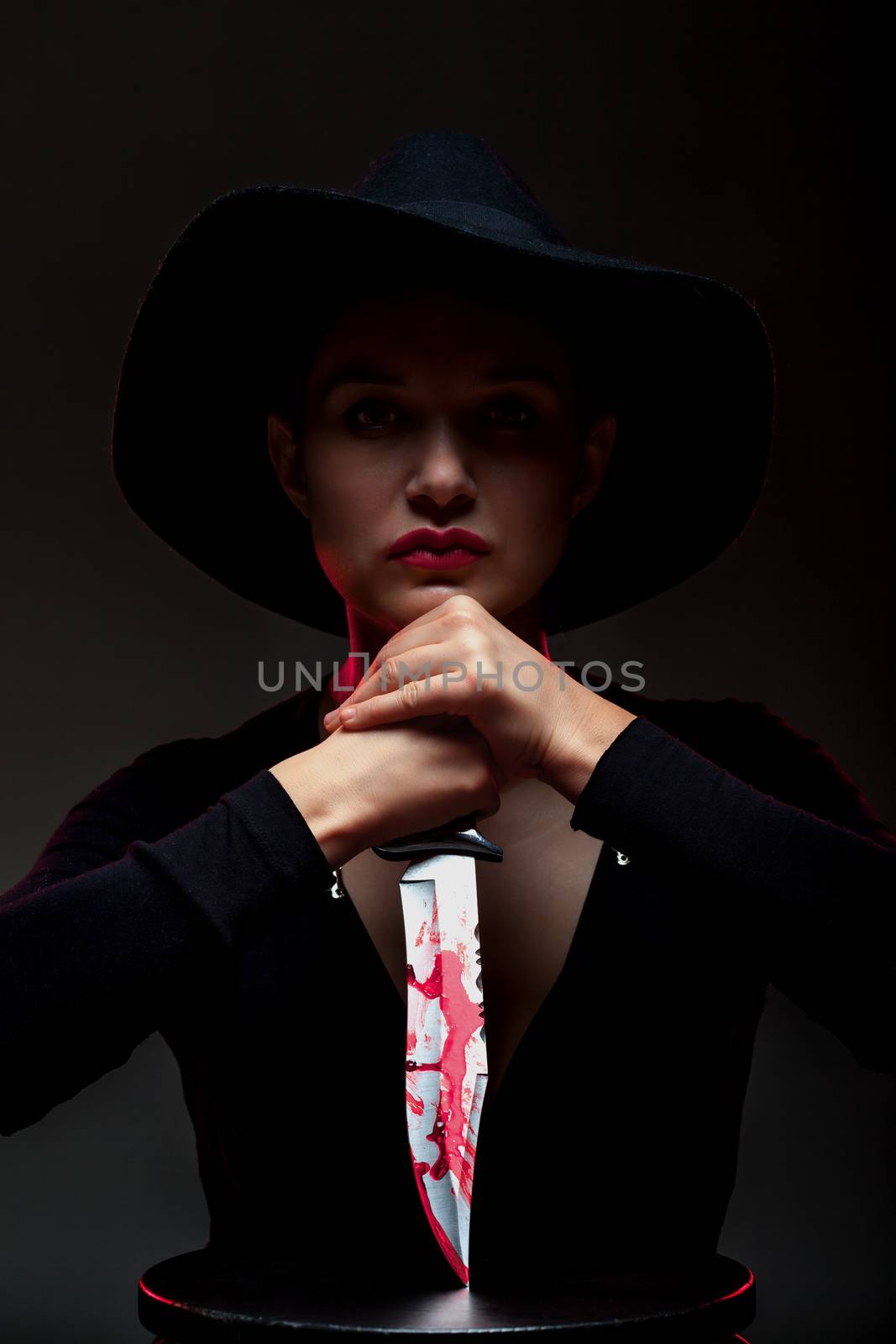 girl with a huge bloody knife in shadow, red backlight