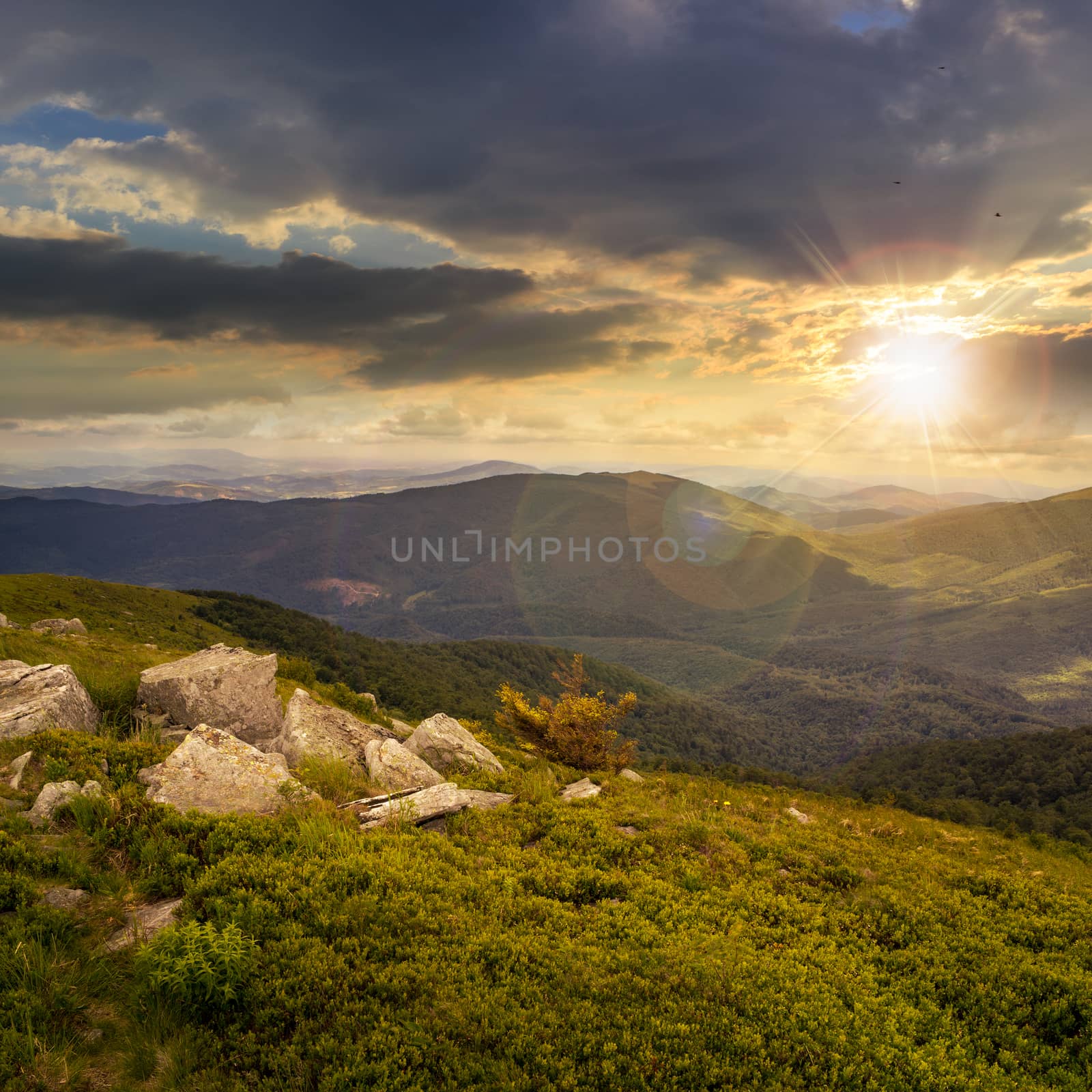 white sharp stones on the hillside of high mountains at sunset