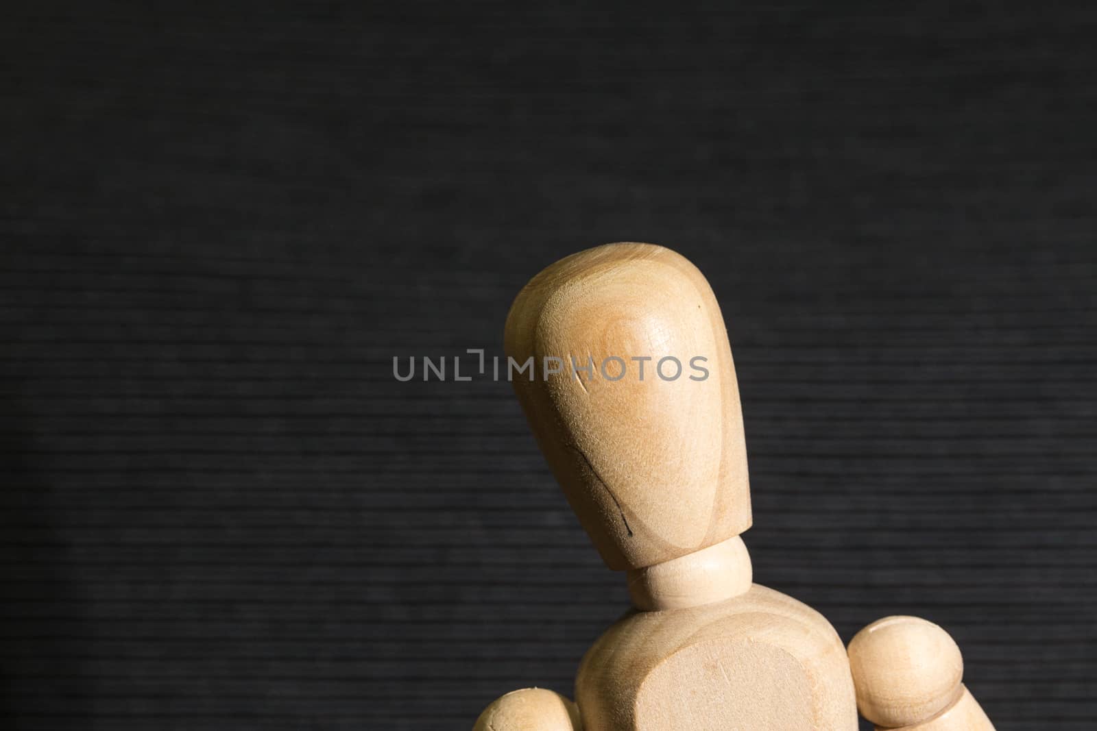 Wooden man on a black background