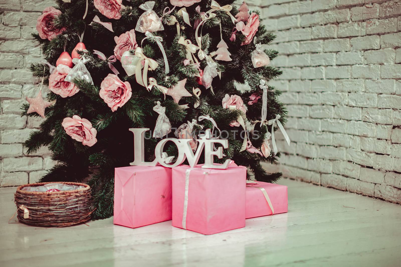 Beautiful holdiay decorated room with Christmas tree with presents under it