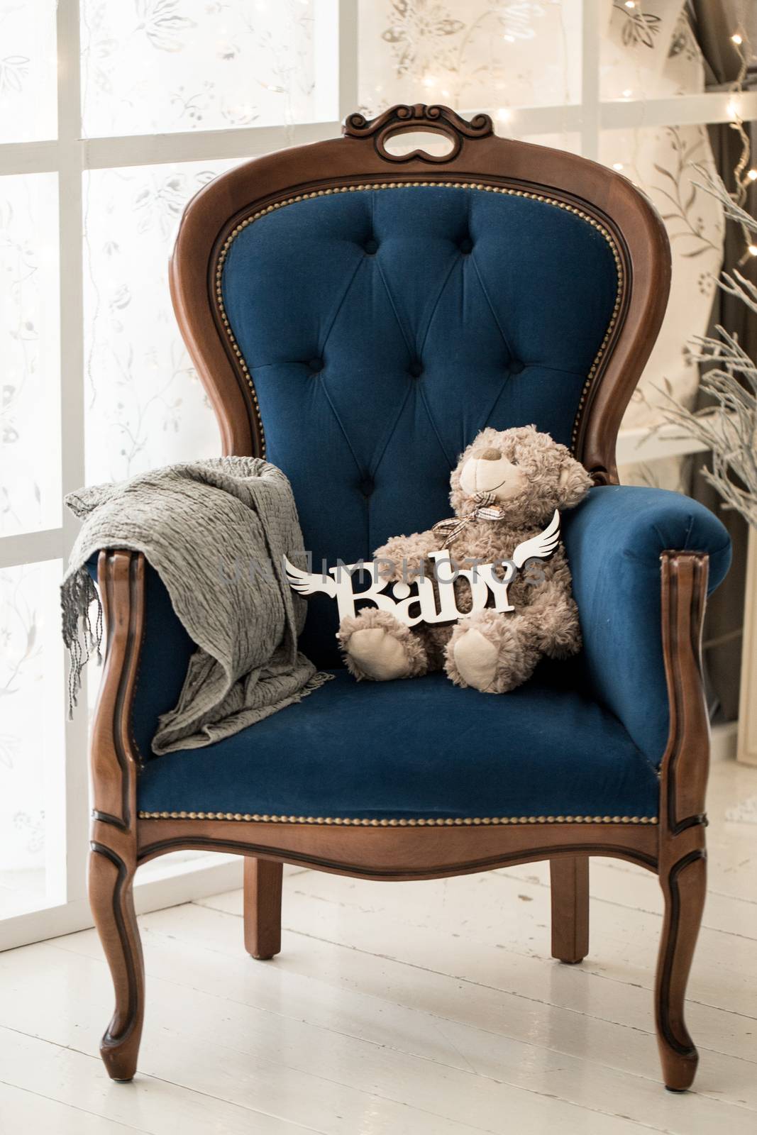 Teddy sitting on vintage armchair