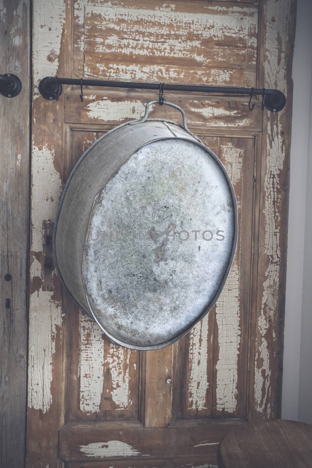 Old stylish iron tub hanging on a wooden wall by Sportactive
