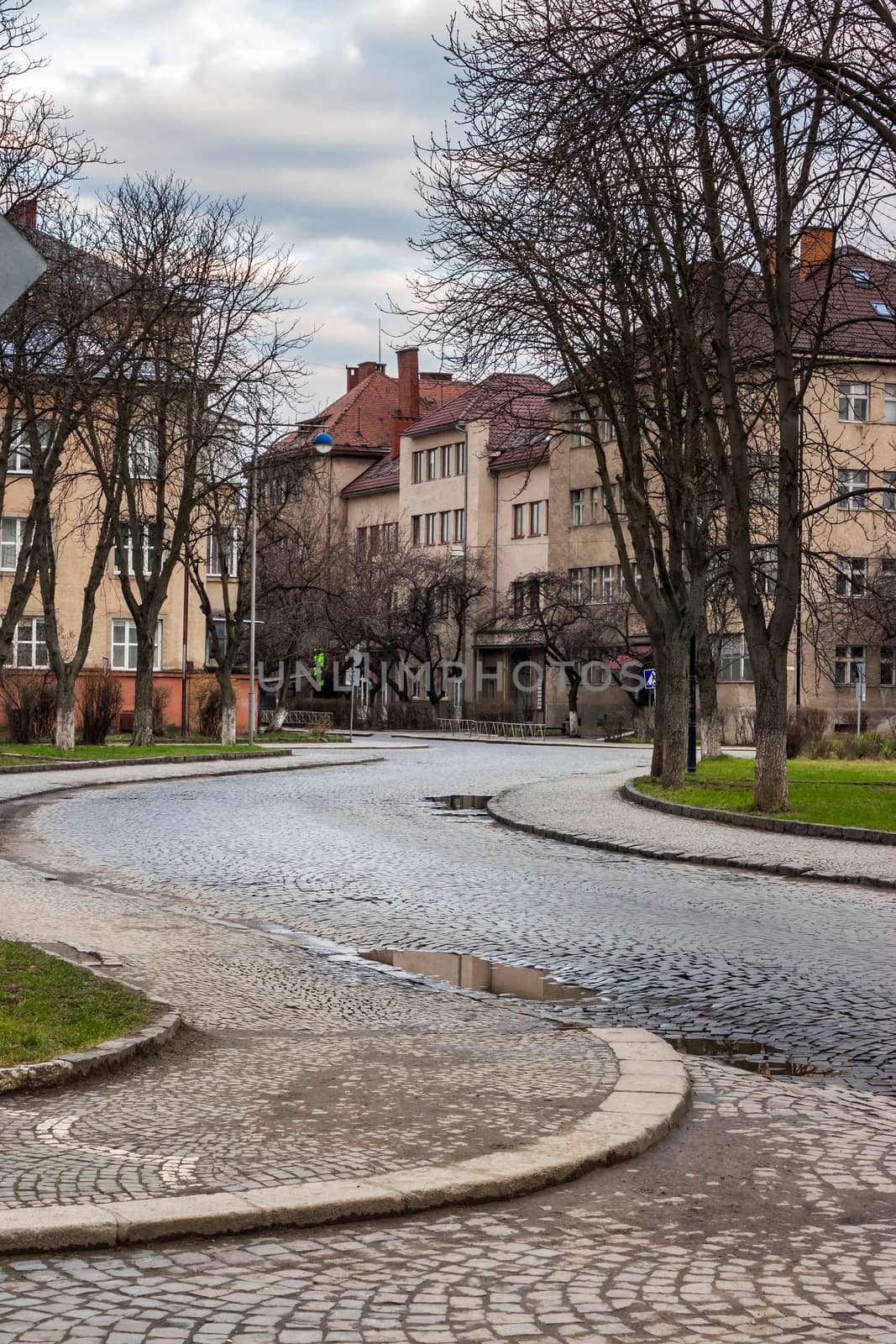 paving winds through the old town near the park in the early morning