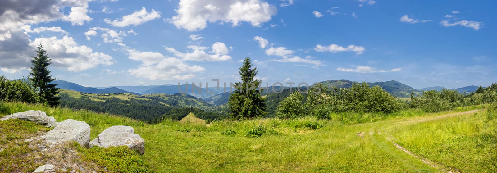 boulders on hillside meadow in mountain by Pellinni