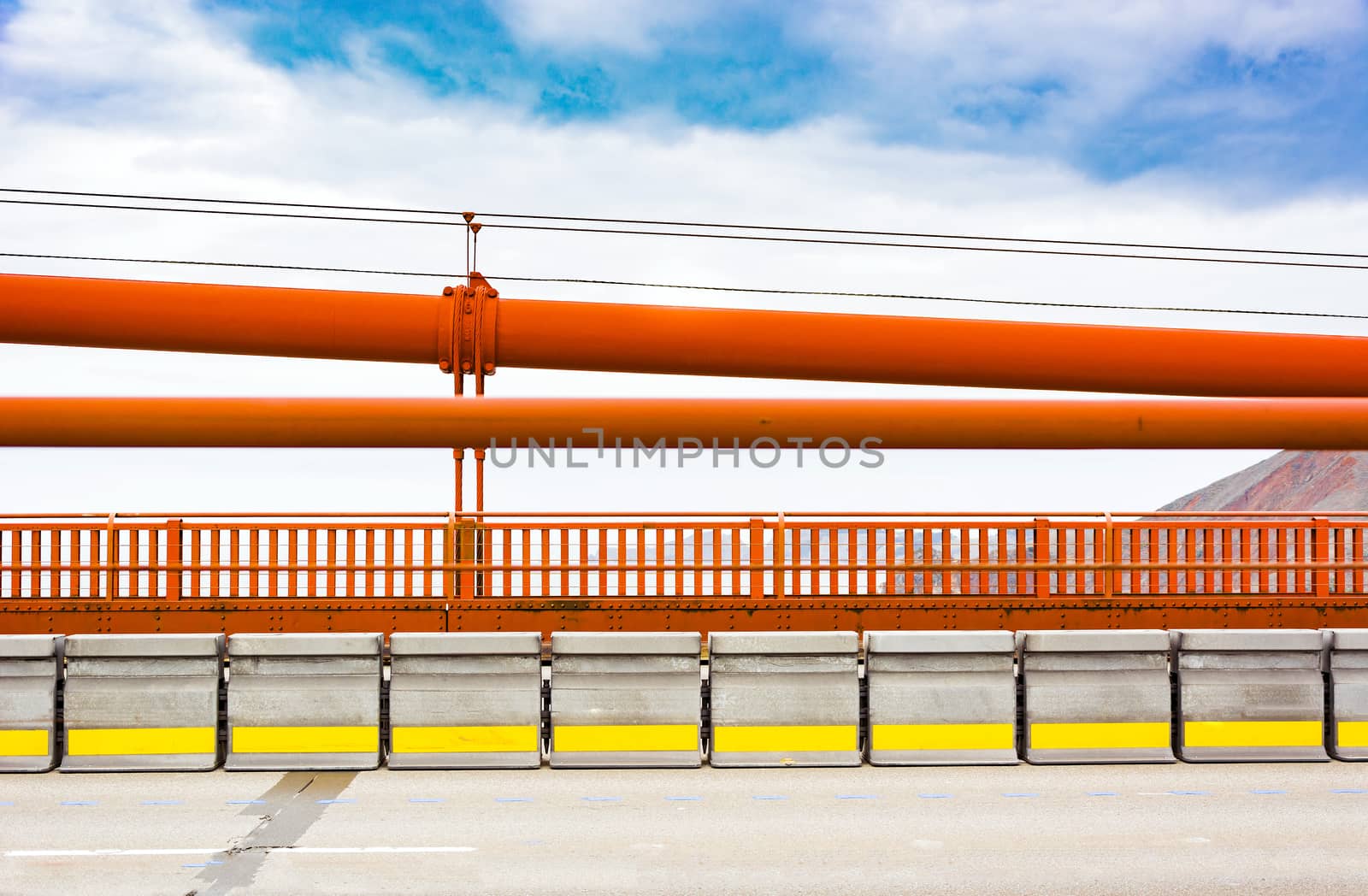 golden gate bridge railings with the iron suspension cables above