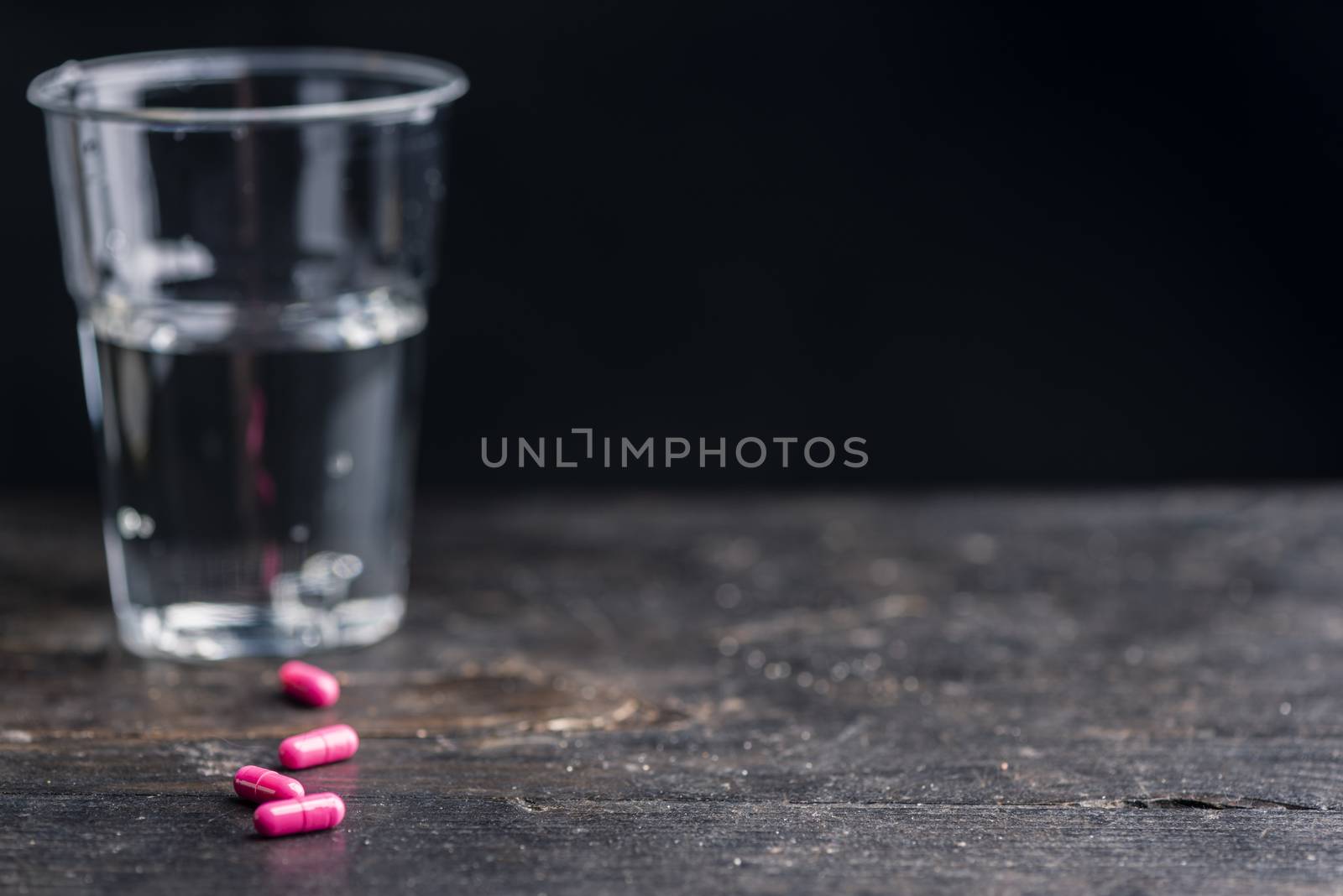 Pills and medicine over a dark table and backrgound.