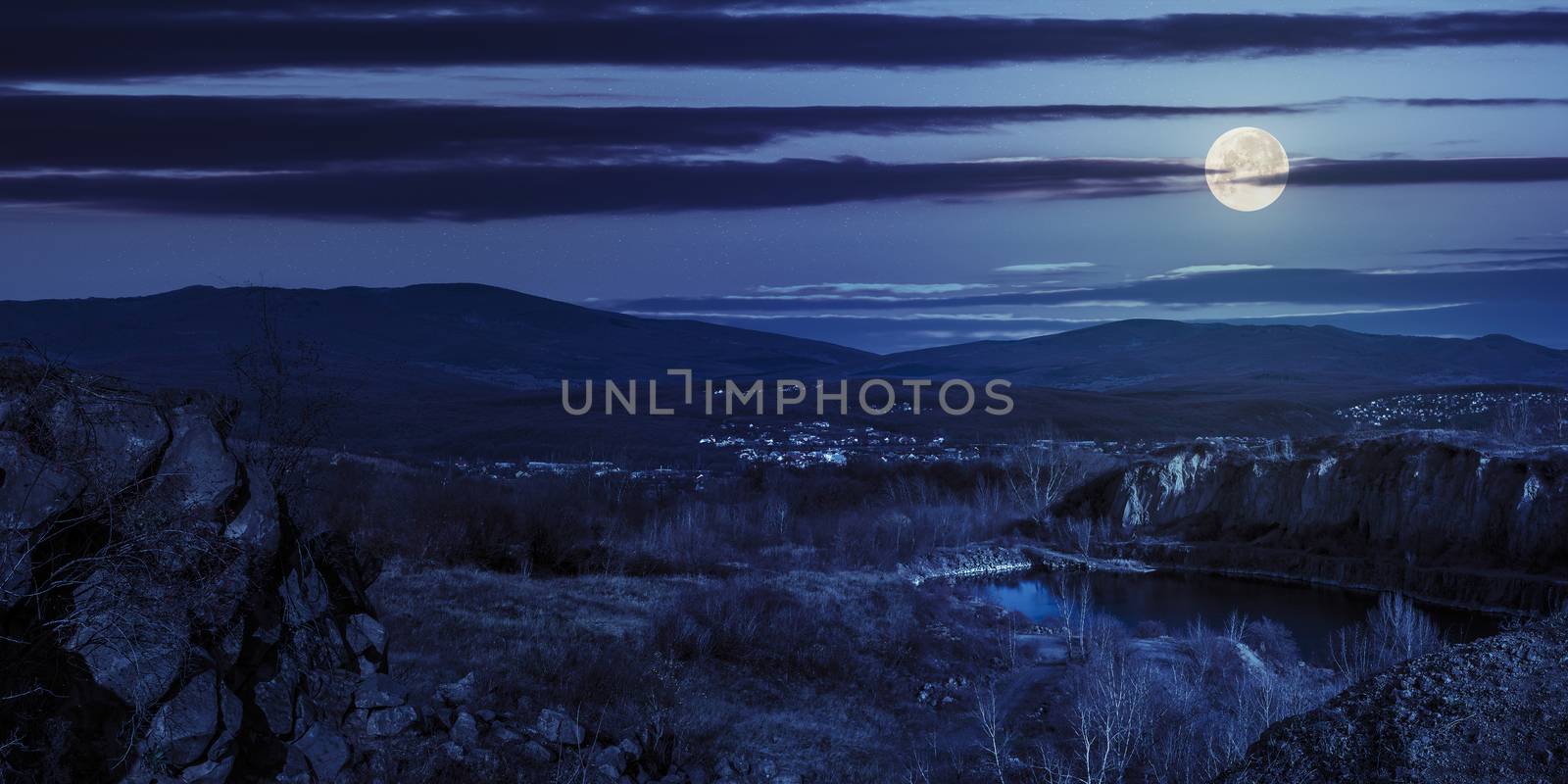 lake in mountains quarry near city at night by Pellinni