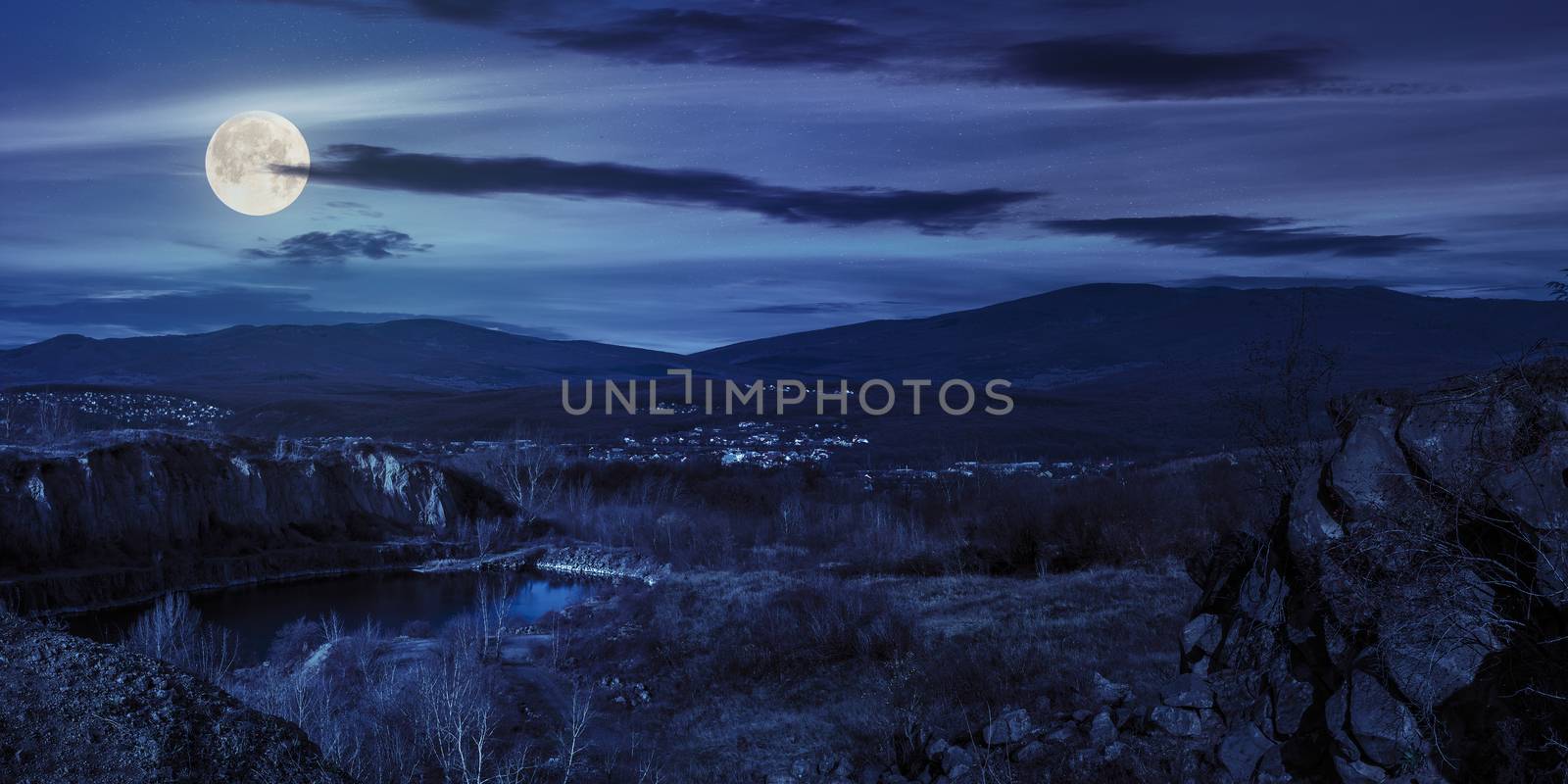 lake in mountains quarry near city at night by Pellinni