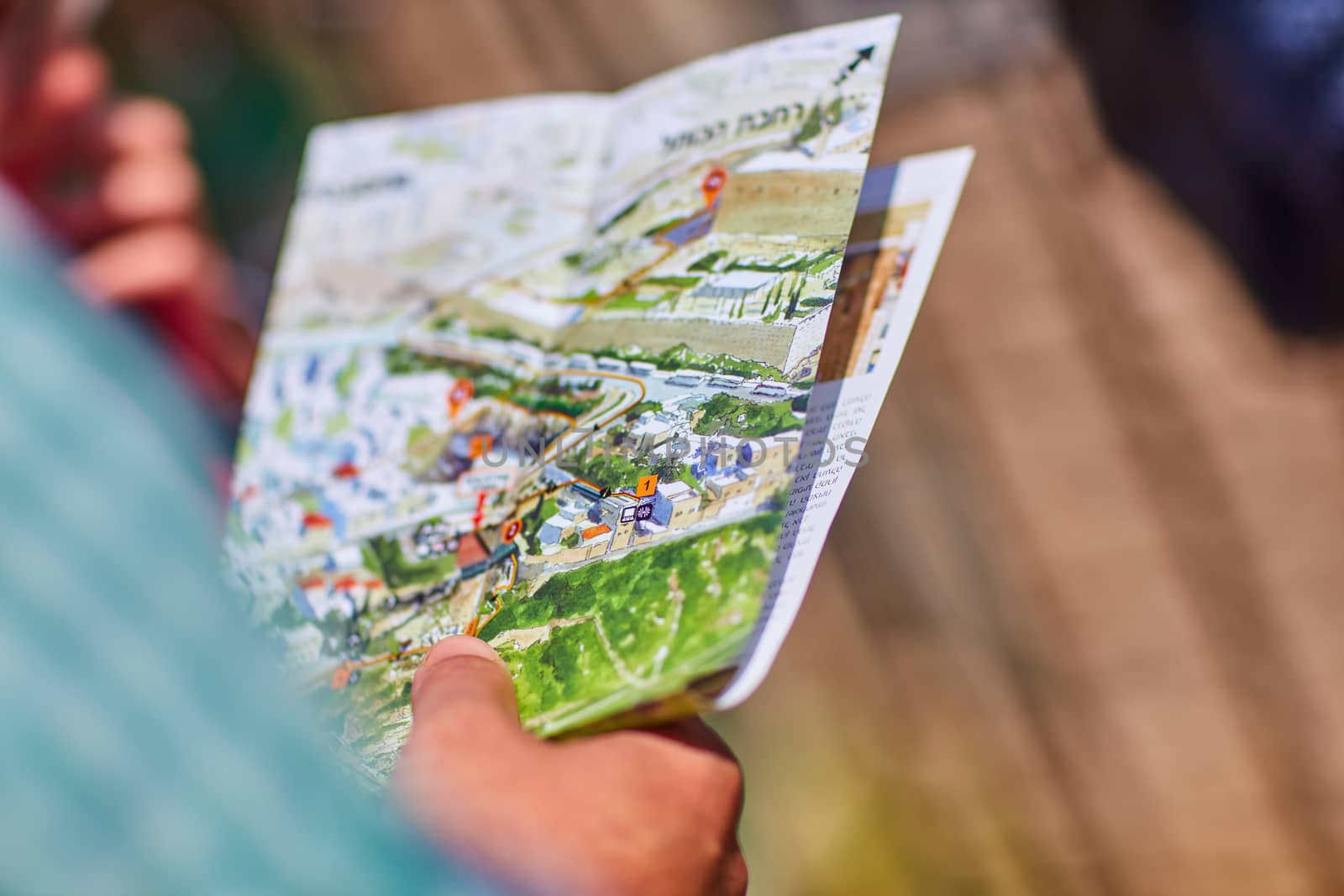 Elderly man holds a map of Jerusalem