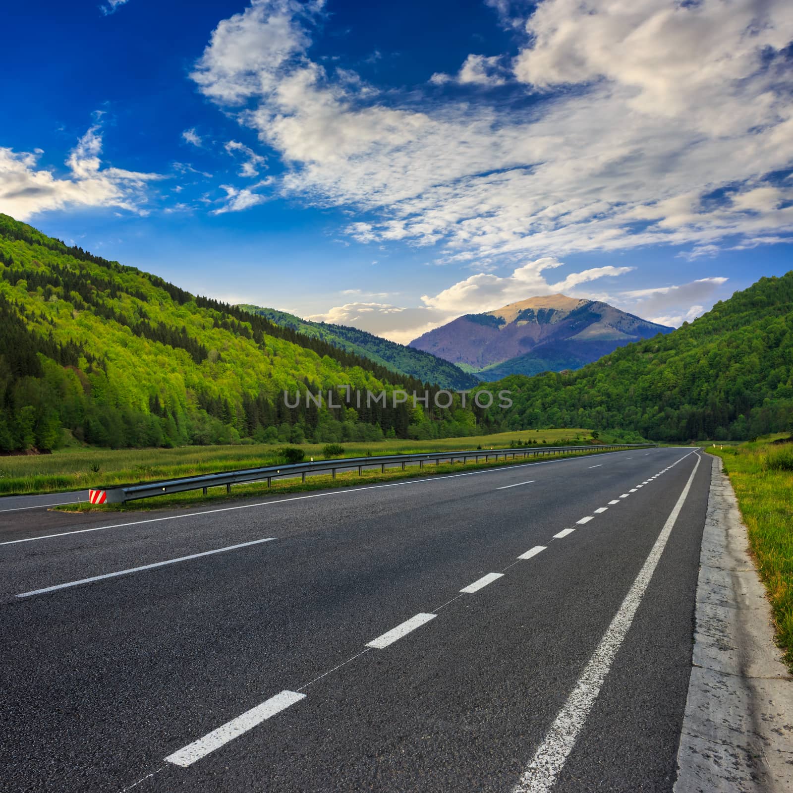 asphalt road in mountains by Pellinni