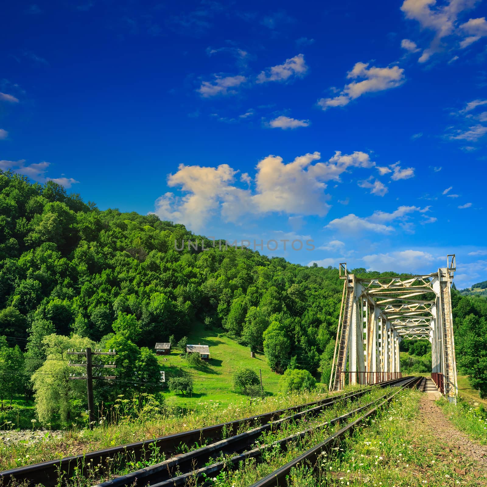 old railroad passes through the metal bridge in the mountain village