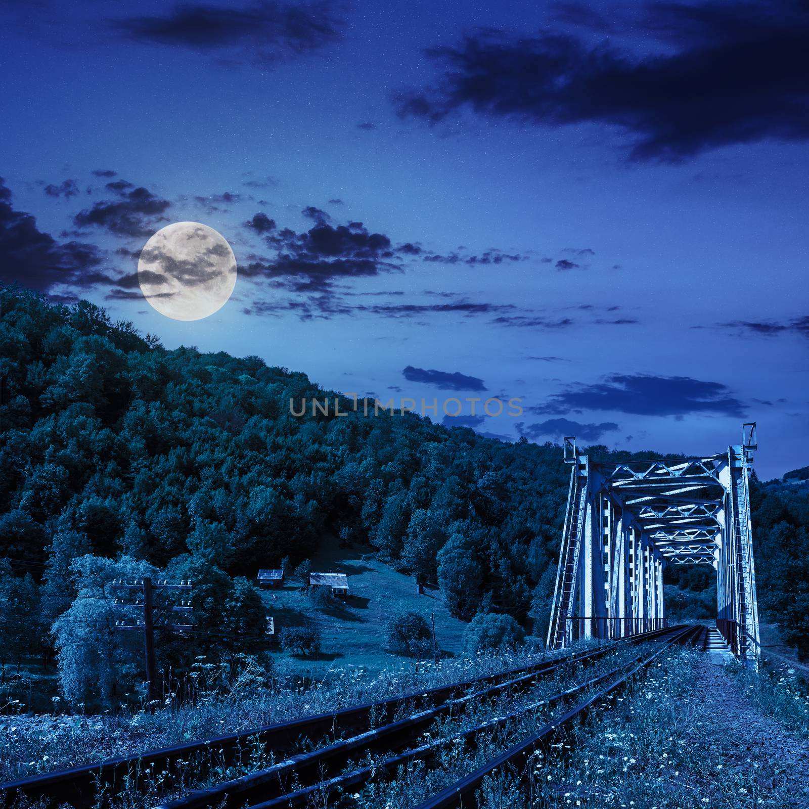 old railroad passes in mountain village at night by Pellinni