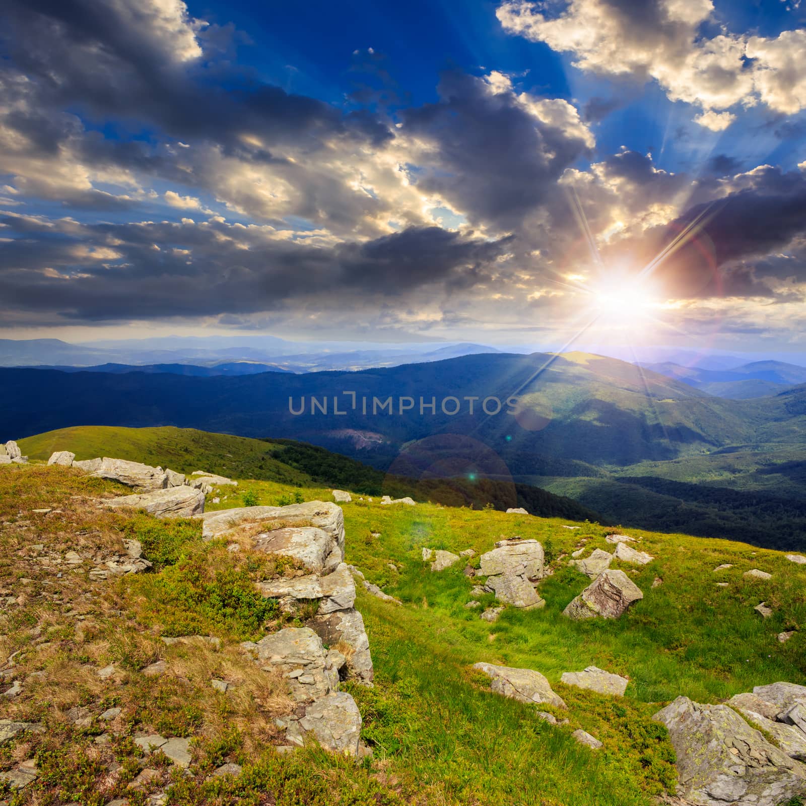 white sharp stones on the hillside in hight mountains at sunset