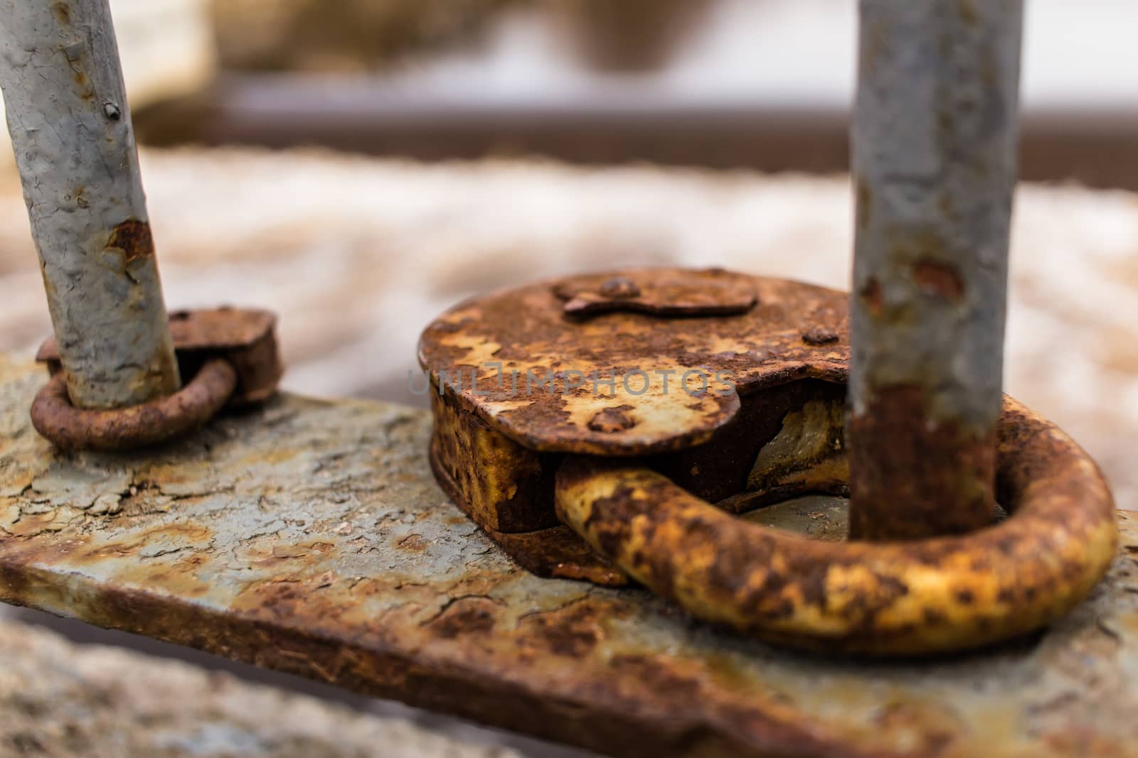 Close-up of two rusty vintage padlocks on the pedestrian bridge fence.