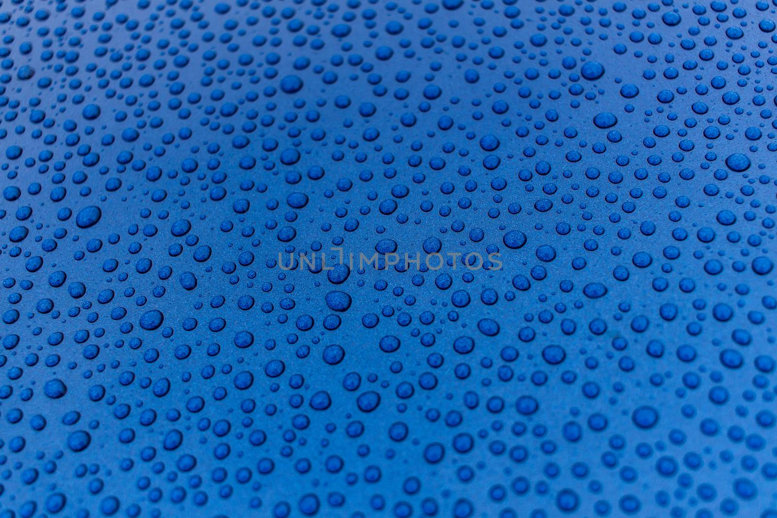 Drops of water on a blue metal surface. by taras_chernenko