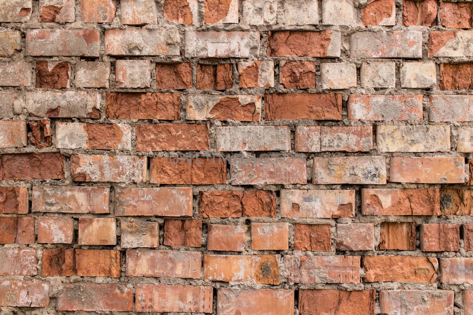 Fragment of weathered red brick wall texture or background.