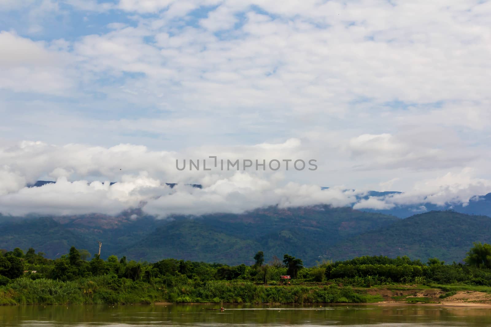 The beautiful landscape with blue sky,white cloud,mountain,river and sand beach.