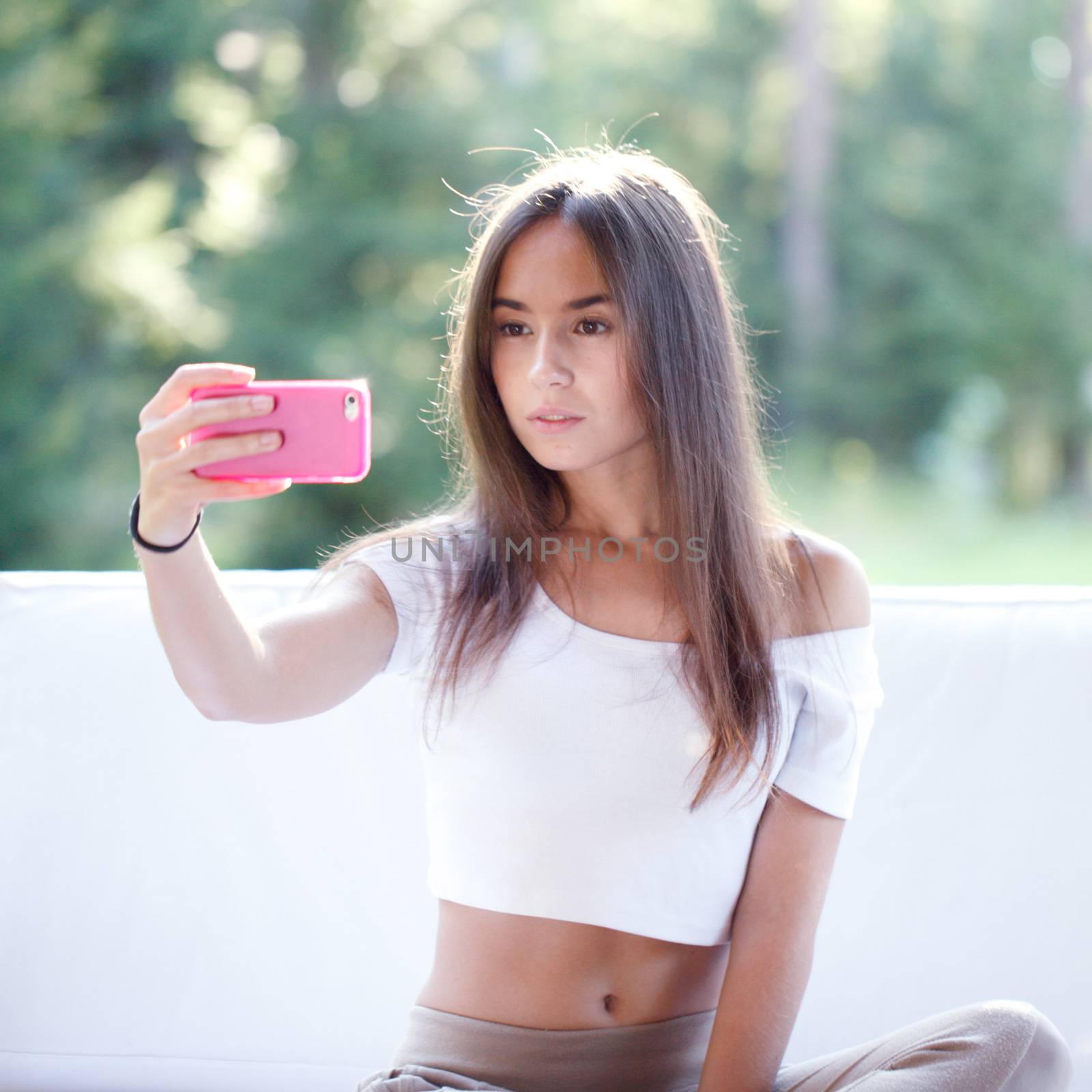 Beautiful young girl take picture with smartphone 