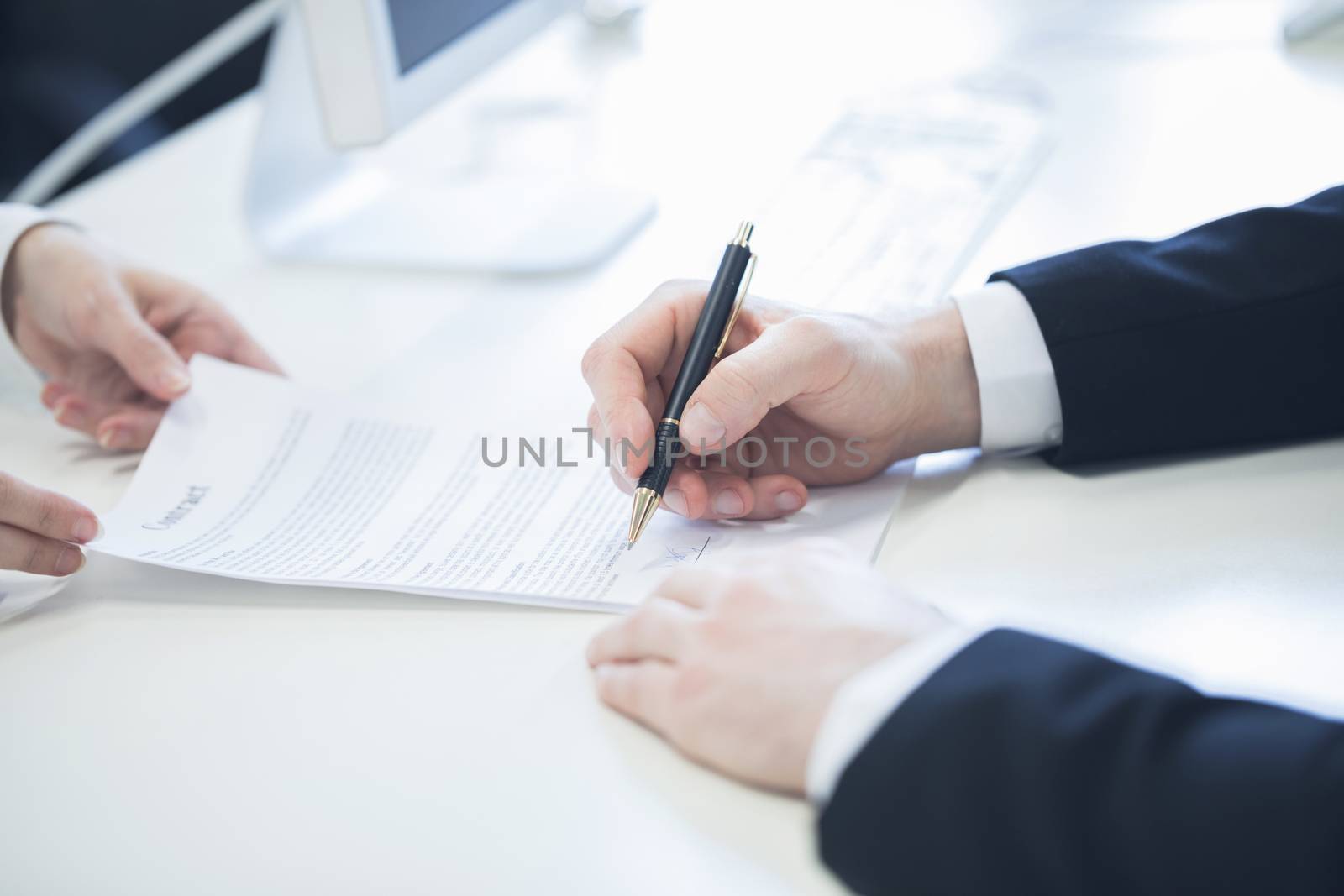 Businessman hands with contract giving it to partner for signing