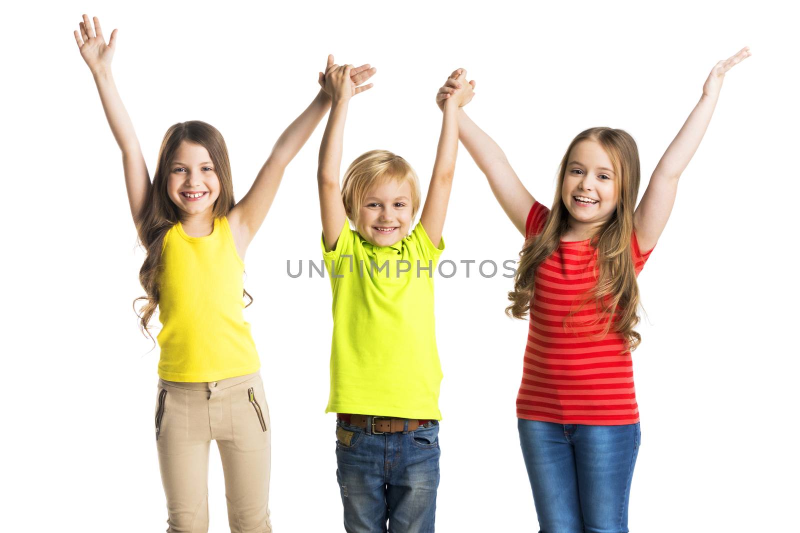 Happy three children holding raised hands isolated on white background