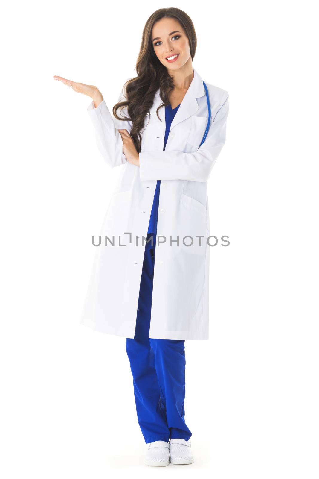 Full body portrait of happy smiling young female doctor showing something or blank area for text, or copyspace, isolated over white background