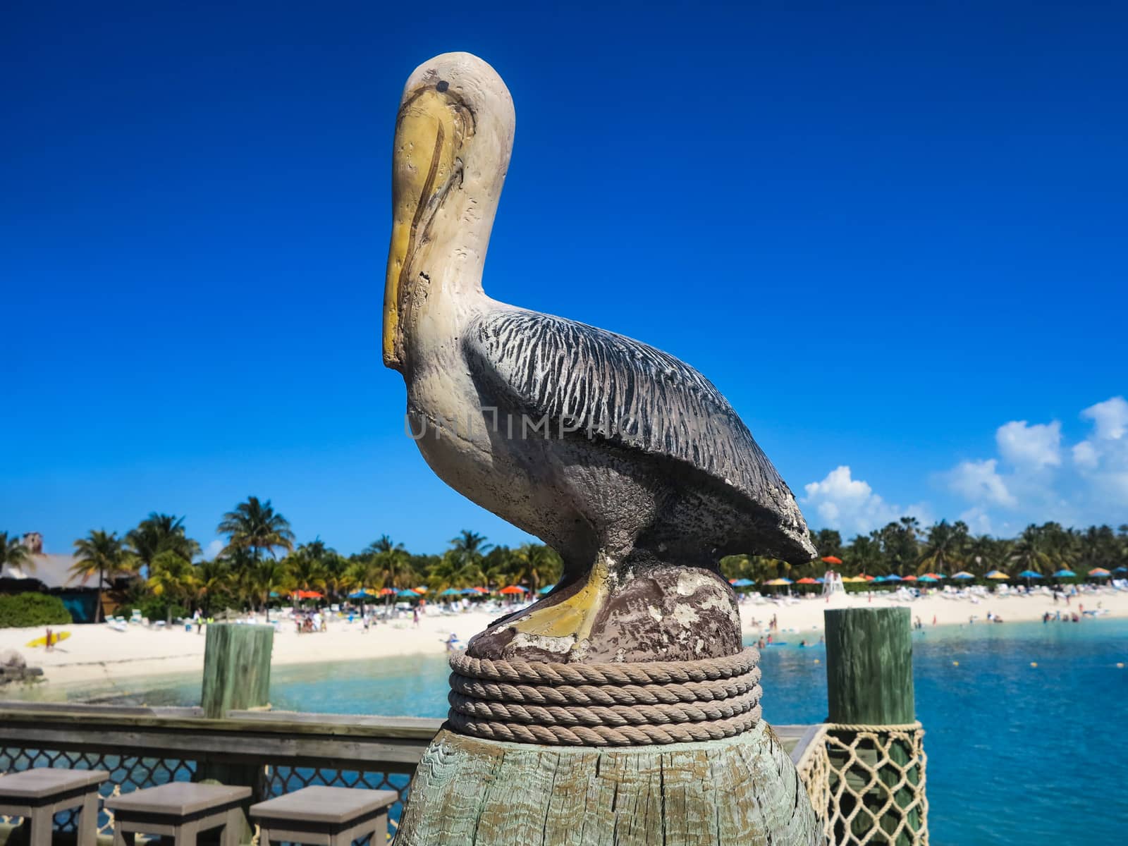 A pelican statue by the beach and ocean