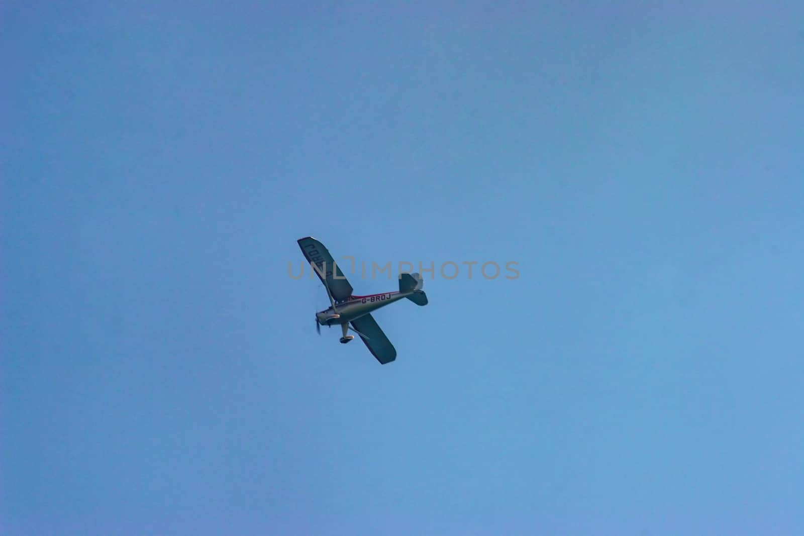 A plane flying through the blue sky